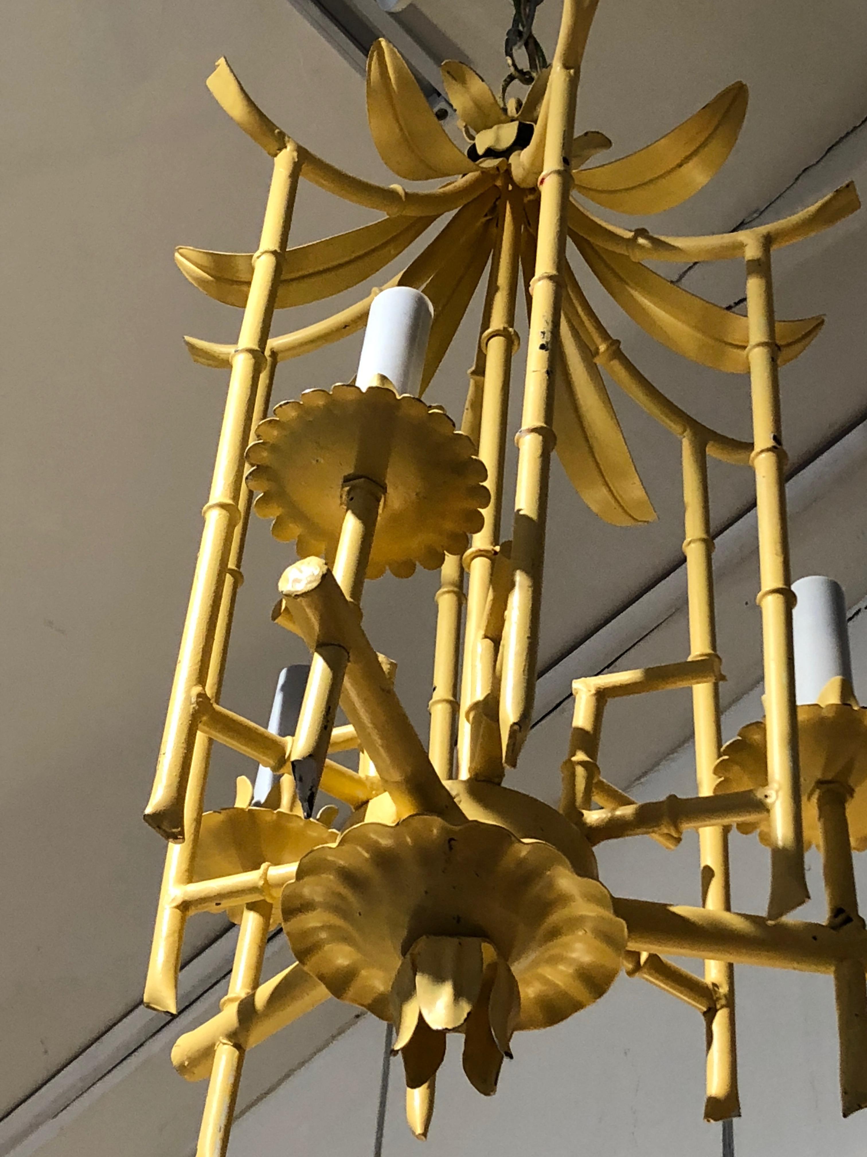 Super chic pale yellow pagoda shaped chandelier, perfect for a hallway or foyer, having 3 arms and wonderful construction of tole, iron and faux bamboo.  We love the color, but this could be easily painted to match any decor.