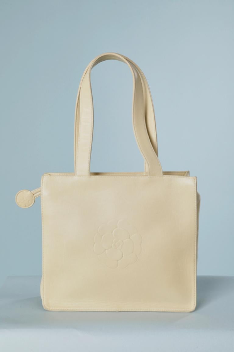 Pale yellow leather hand bag with embossed 