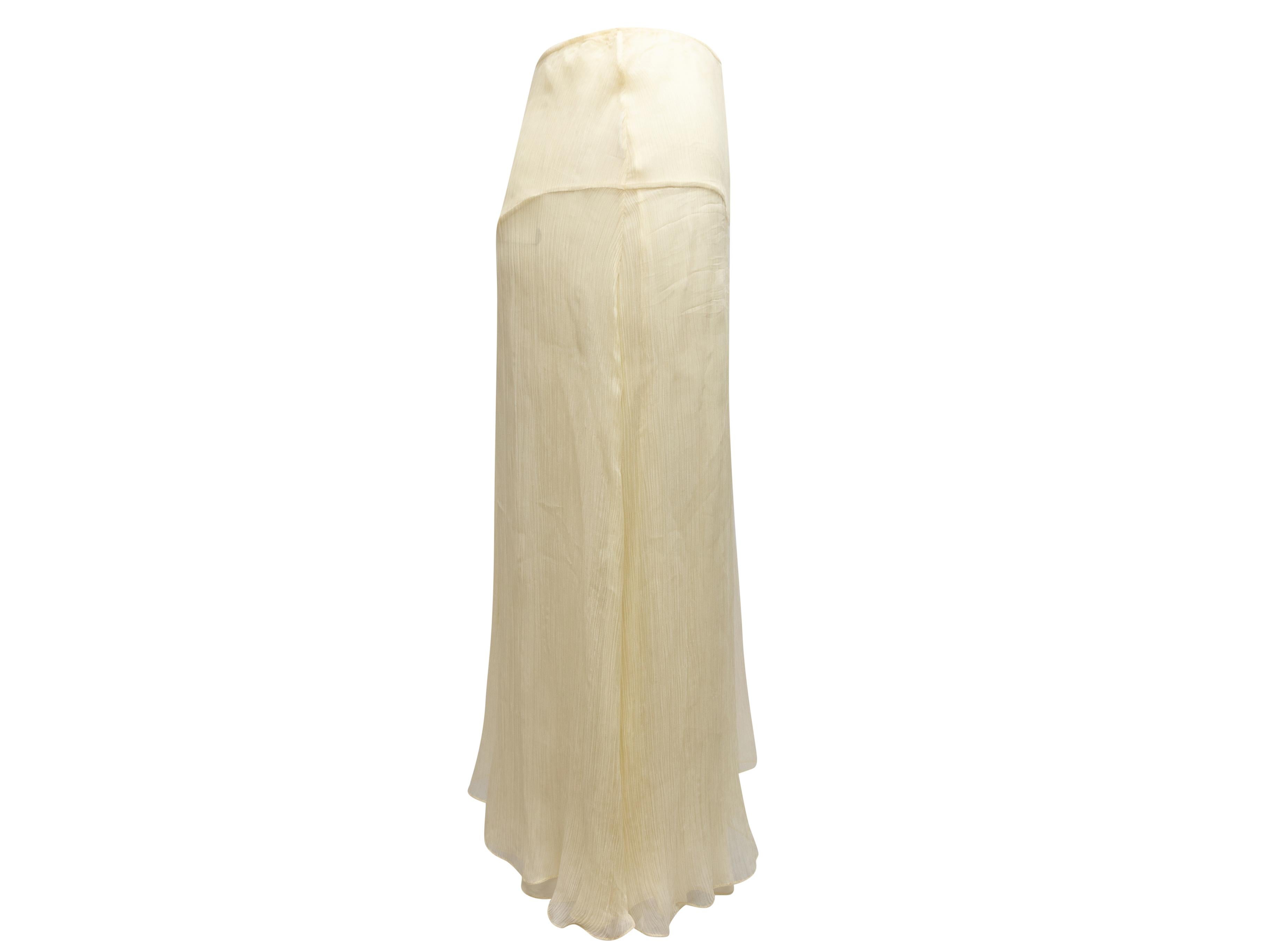Pale yellow and multicolor knee-length skirt by Moschino Couture. Bead-embellished woman applique accent at front. Side closure. 25