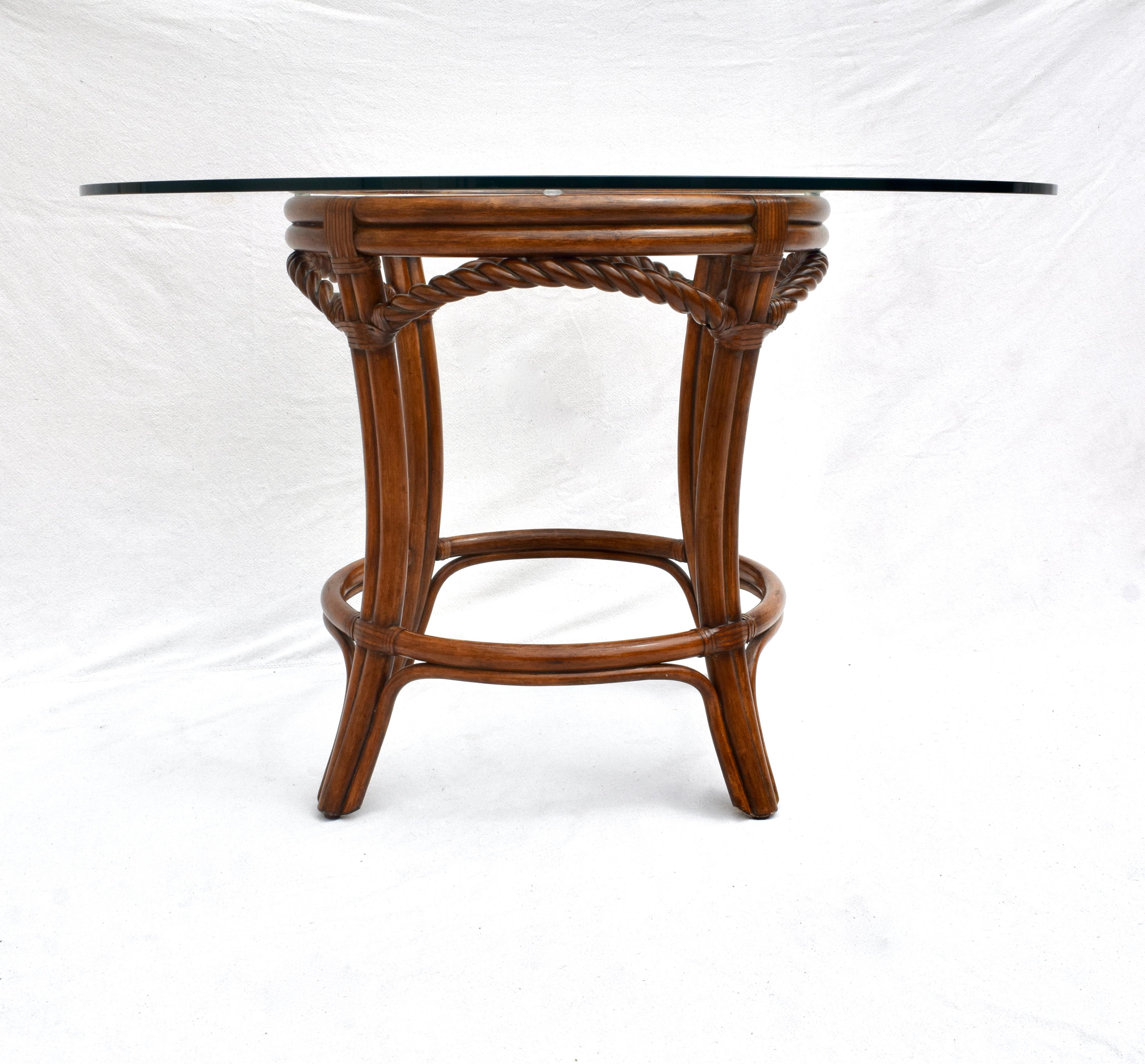 A fine Palecek French Regency style center or pedestal dining table of faux bamboo & braided rope styling accented with leather joinery in excellent vintage condition.  Table dimensions: 48