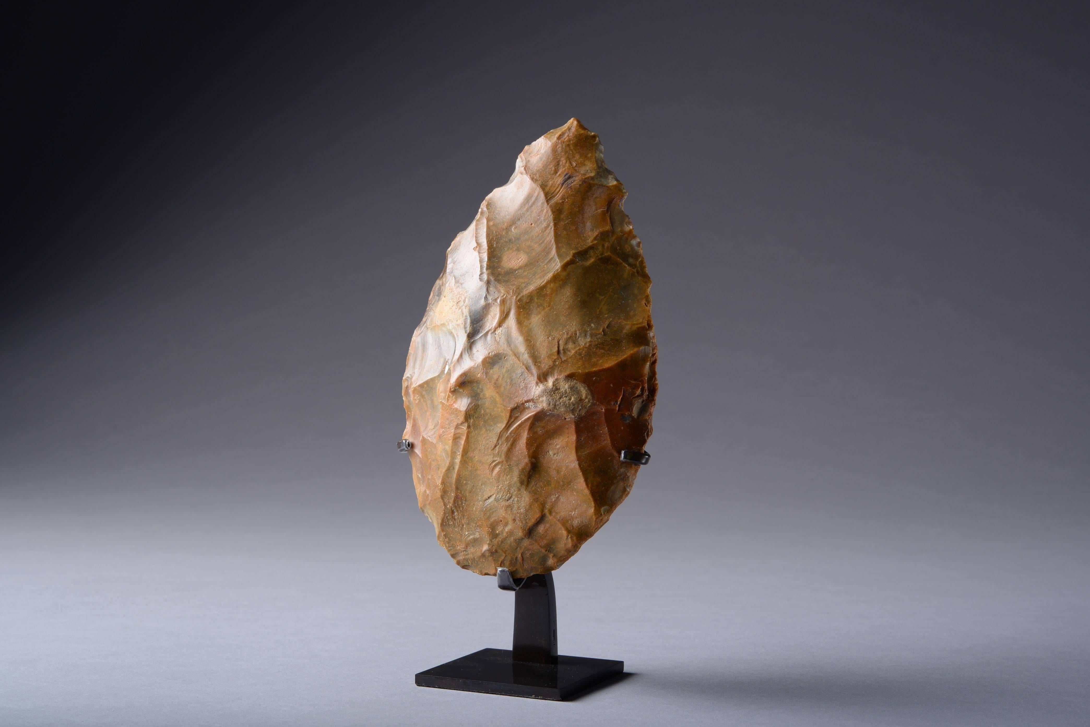 A large Acheulian flint hand axe, likely produced by Homo erectus. Found in northern France, dating to around 800,000 - 100,000 years ago.

Worked from a substantial boulder of flint and knapped into the typical tear-drop form.

An impressive