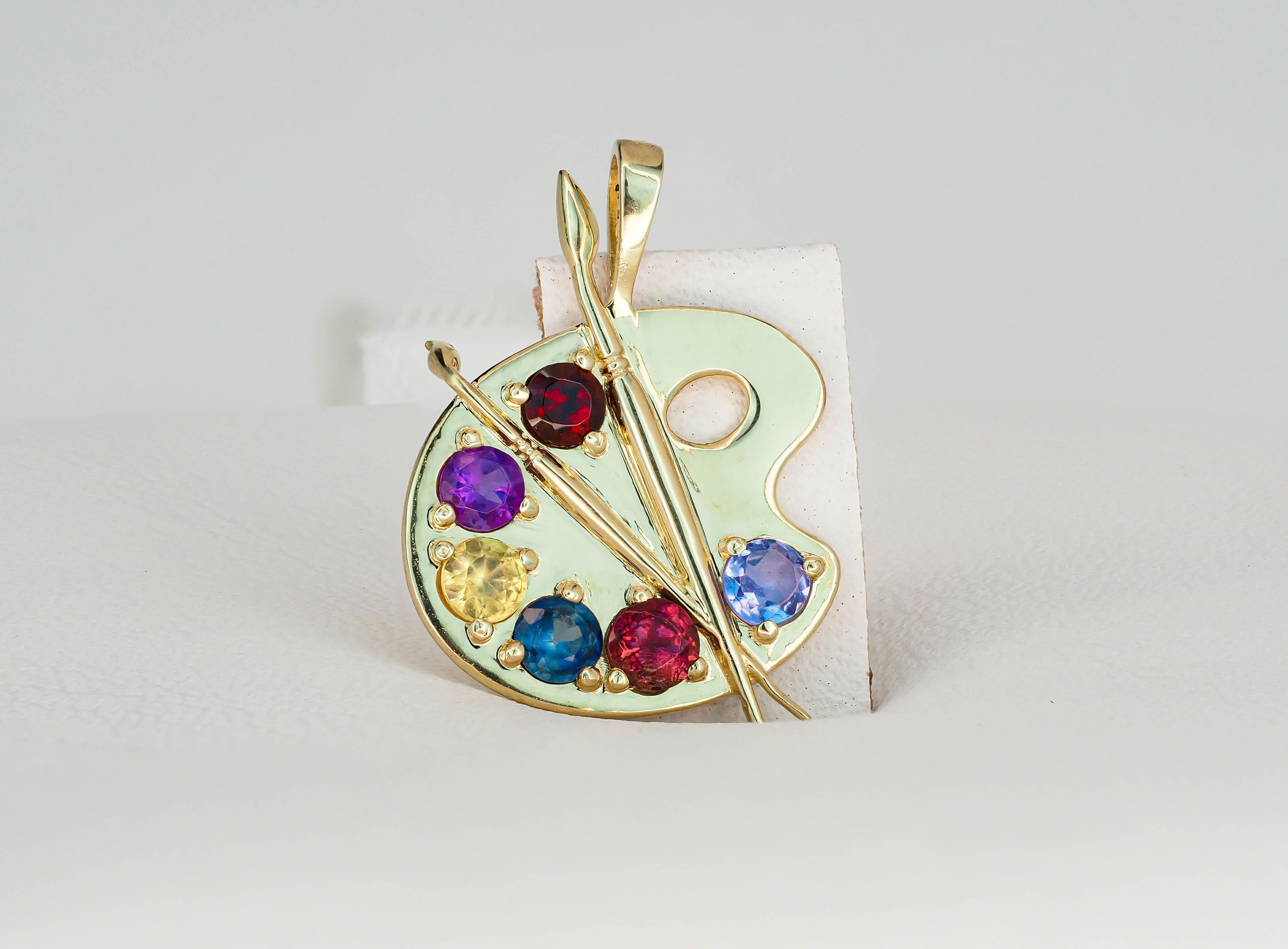 Palette with paints 14 kt solid gold pendant with colored stones.
14 kt solid yellow gold
Size: 17.6 x 18 mm.
Total weight 1.61 g.

Natural gemstones:
Amethyst, sapphires, tanzanite, garnet - 6 stones
Round shape, colors - bluegreen, violet, red,