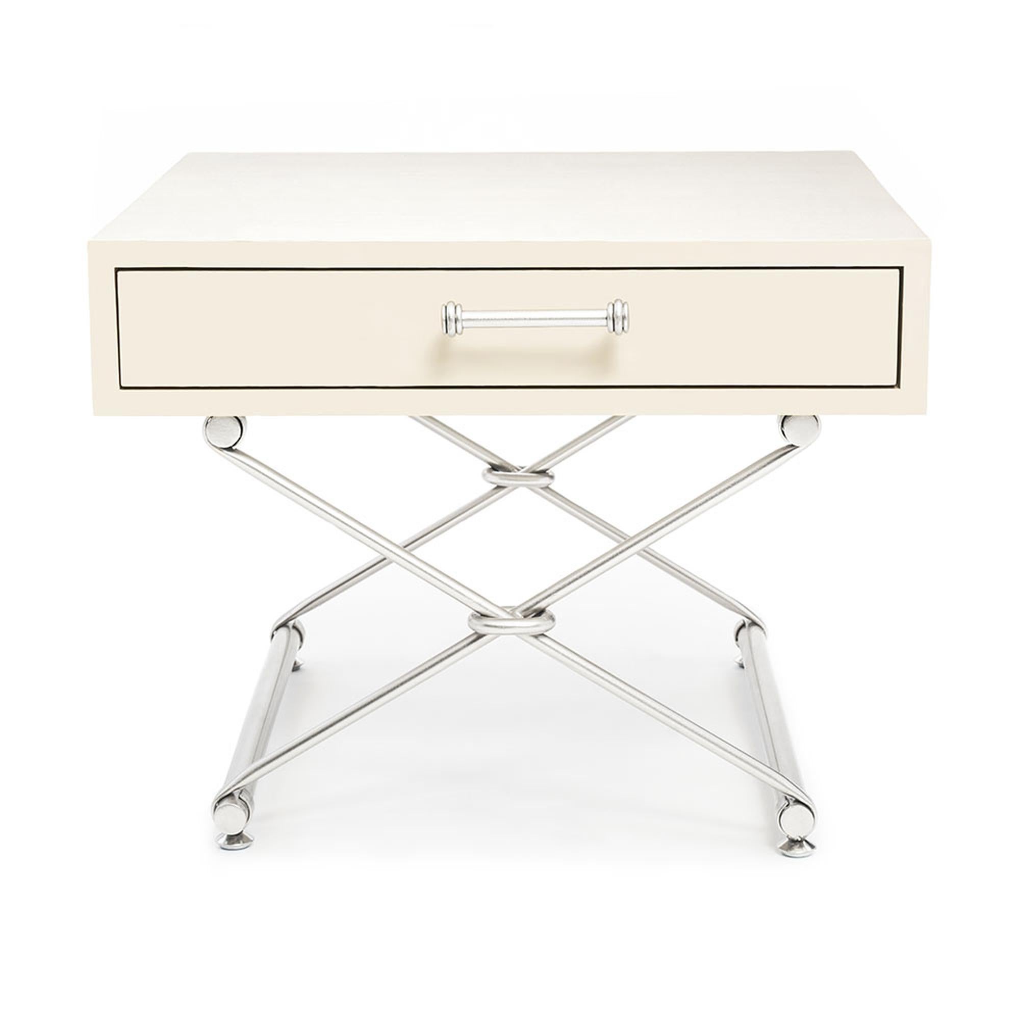 The Palisades accent table II is radiates laid-back sophistication. The table top, made of solid wood, features a soft-close drawer and sits atop a hand-gilded double-pair of legs in an “X” formation. The legs seamlessly wrap around a set of