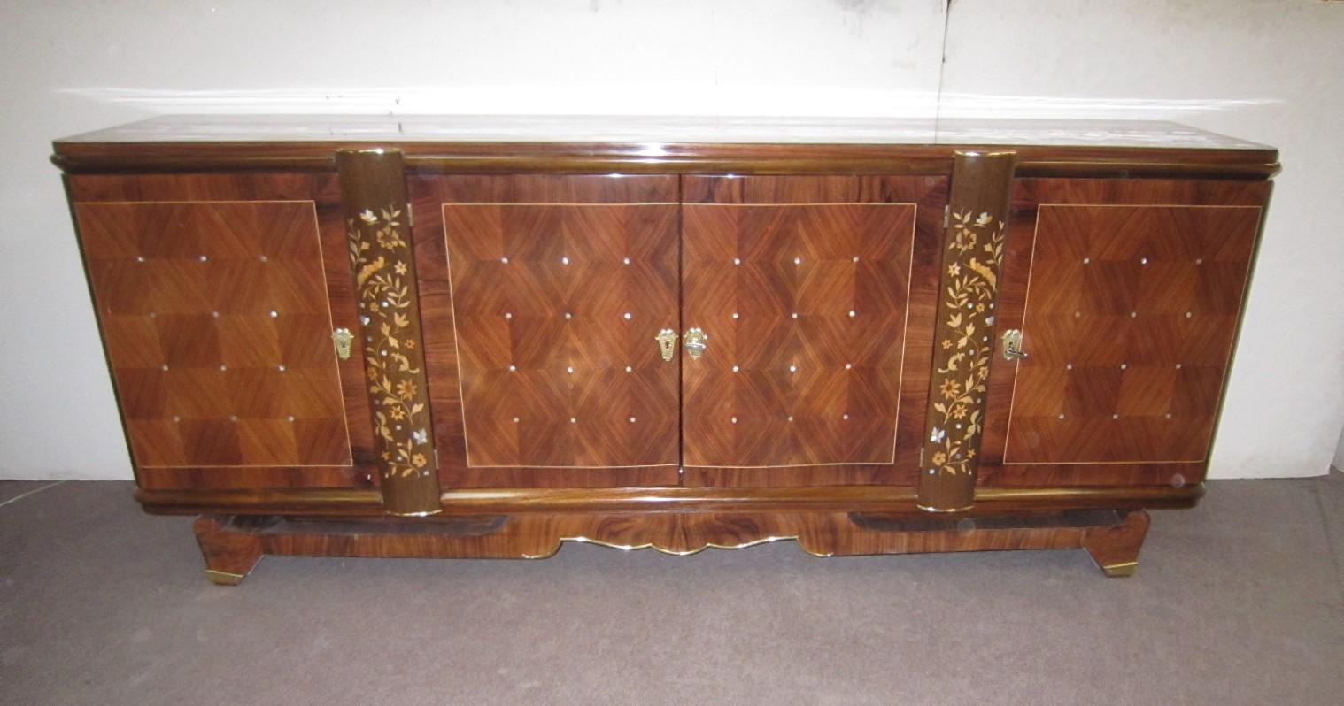 An exceptional French Moderne credenza in palisander and walnut veneer with inlaid parquetry and marquetry features in exotic woods.
Elegantly dotted patterns on parquetry doors combined with floral and animal marquetry details on intersecting