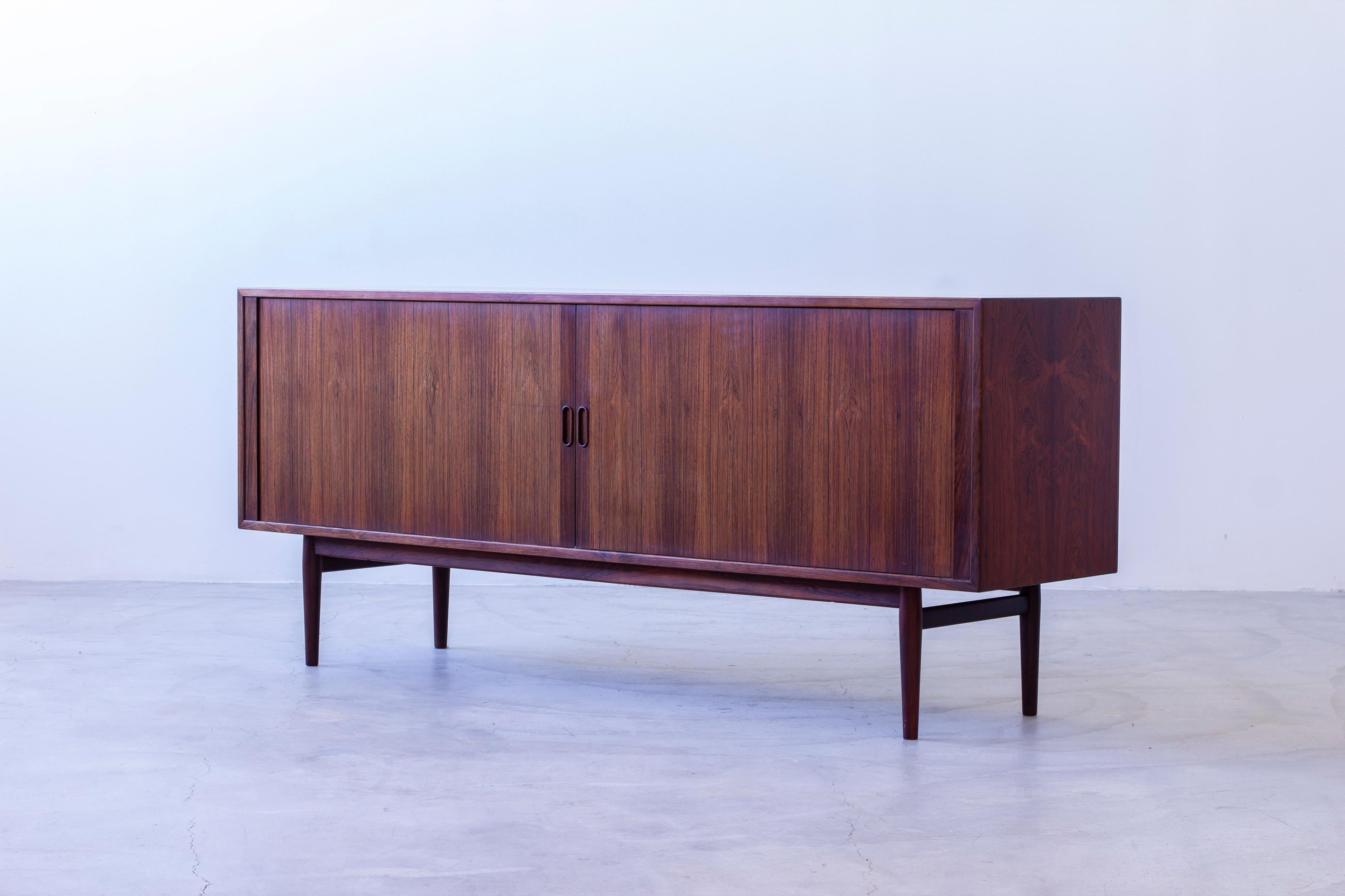  Sideboard designed by Arne Vodder. produced in Denmark by Sibast Furniture during the 1950s. Very nice quality throughout with sliding tambour doors tapered legs and beautiful details and attention to all wooden details and veneers chosen for the