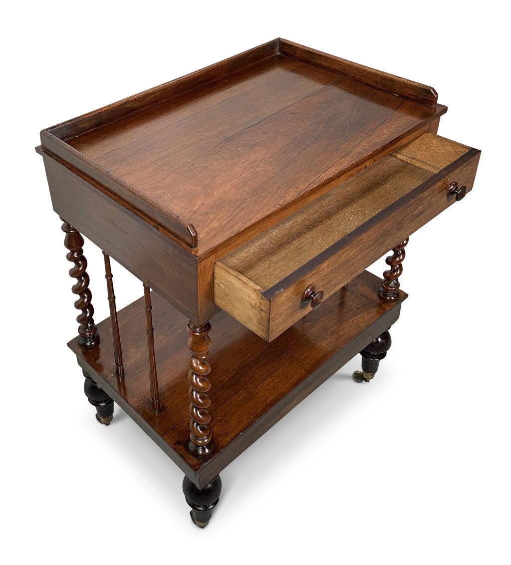 19th century French palissandre two tier side table.
Four barley twist turned legs.
Lower open shelf.
Single drawer.
Four casters on brass fastenings.
Arriving TBD.
