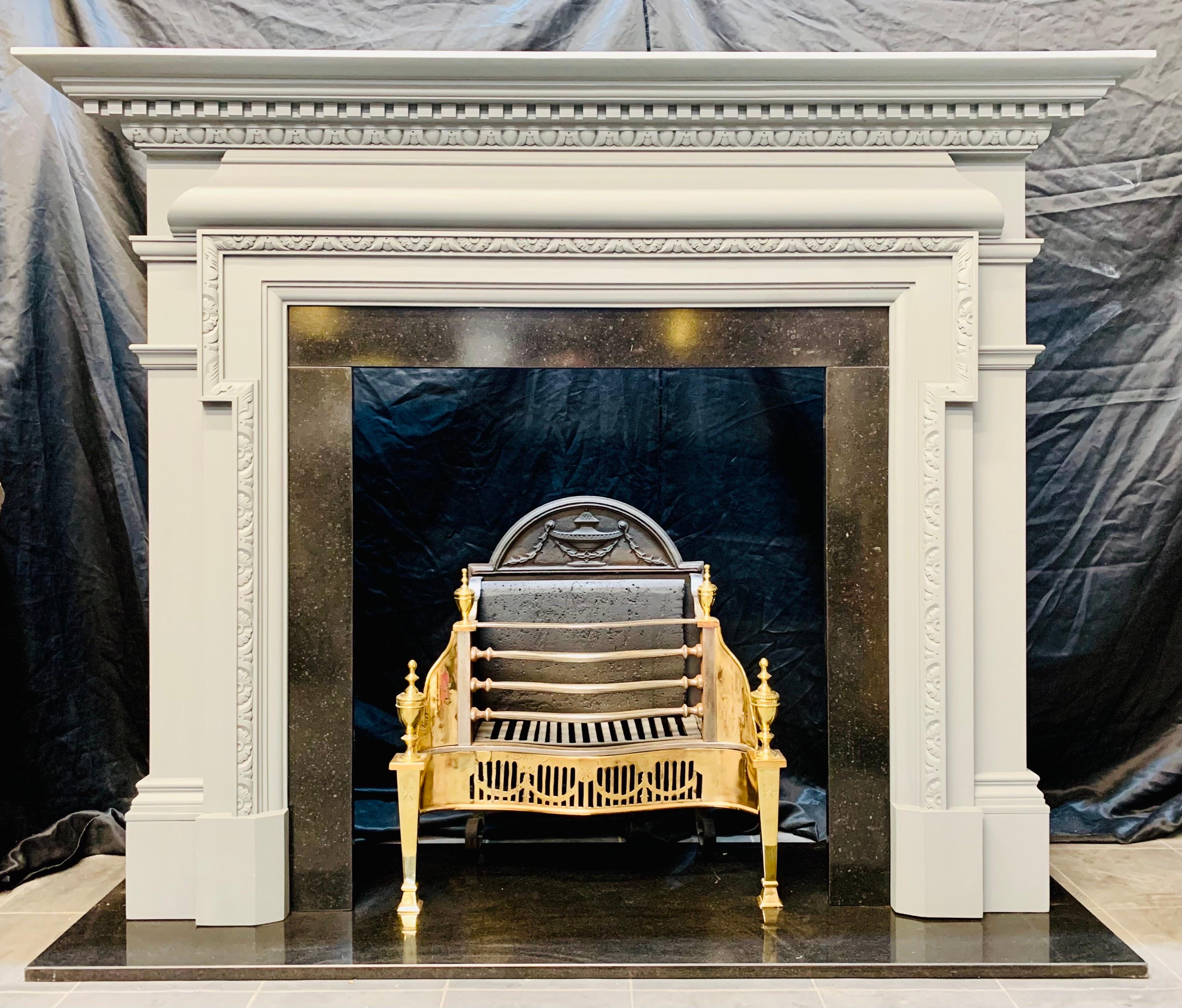 A substantial hardwood Palladian manner fireplace surround. A moulded top shelf, with dental check below- a wrap around top cornice of carved egg & dart moulding, below a Bolection section to frieze. The fireplace opening is framed by further carved