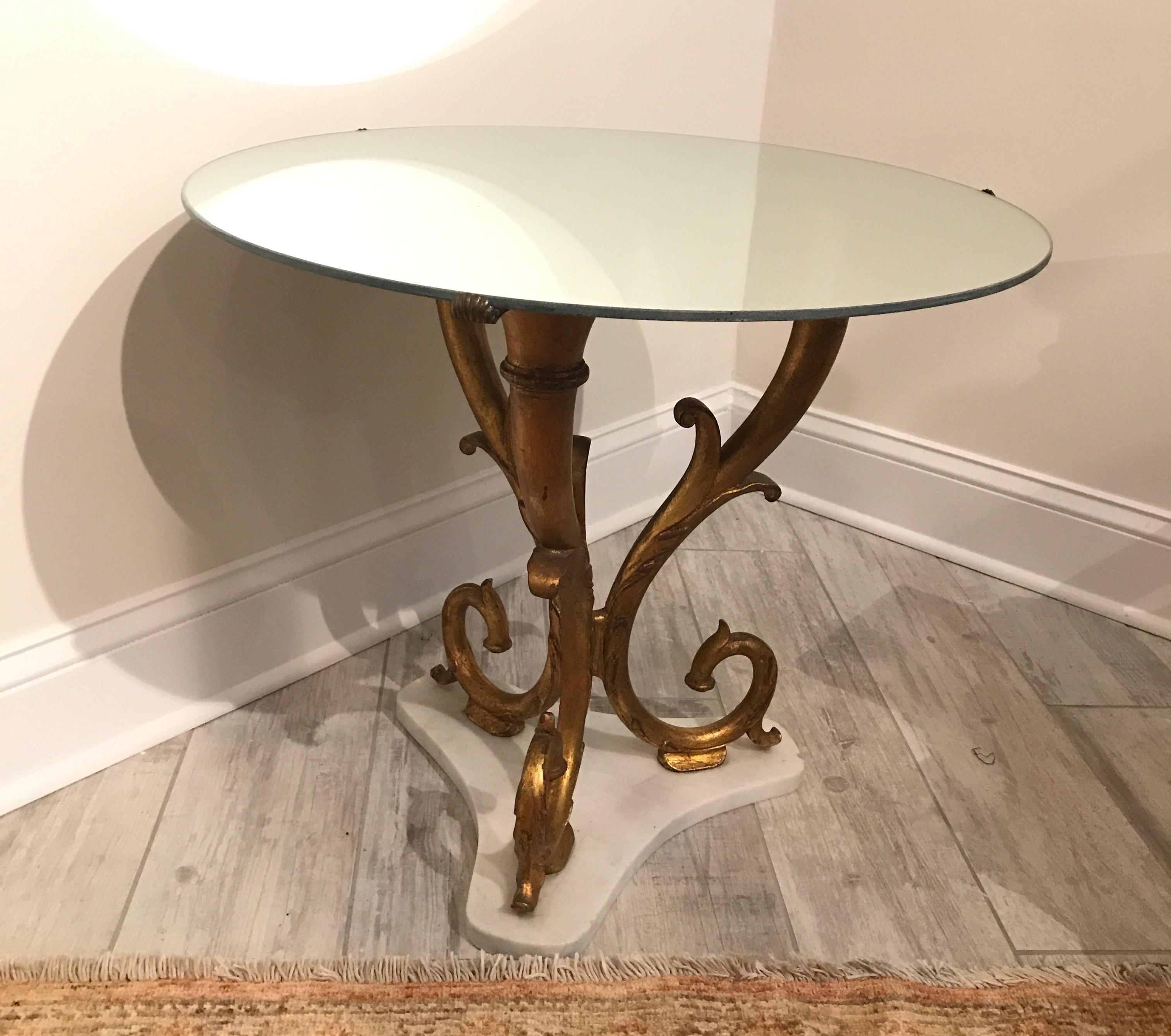 Round gilded iron side table with white marble base and mirrored top. This is a vintage Italian table by Palladio.
