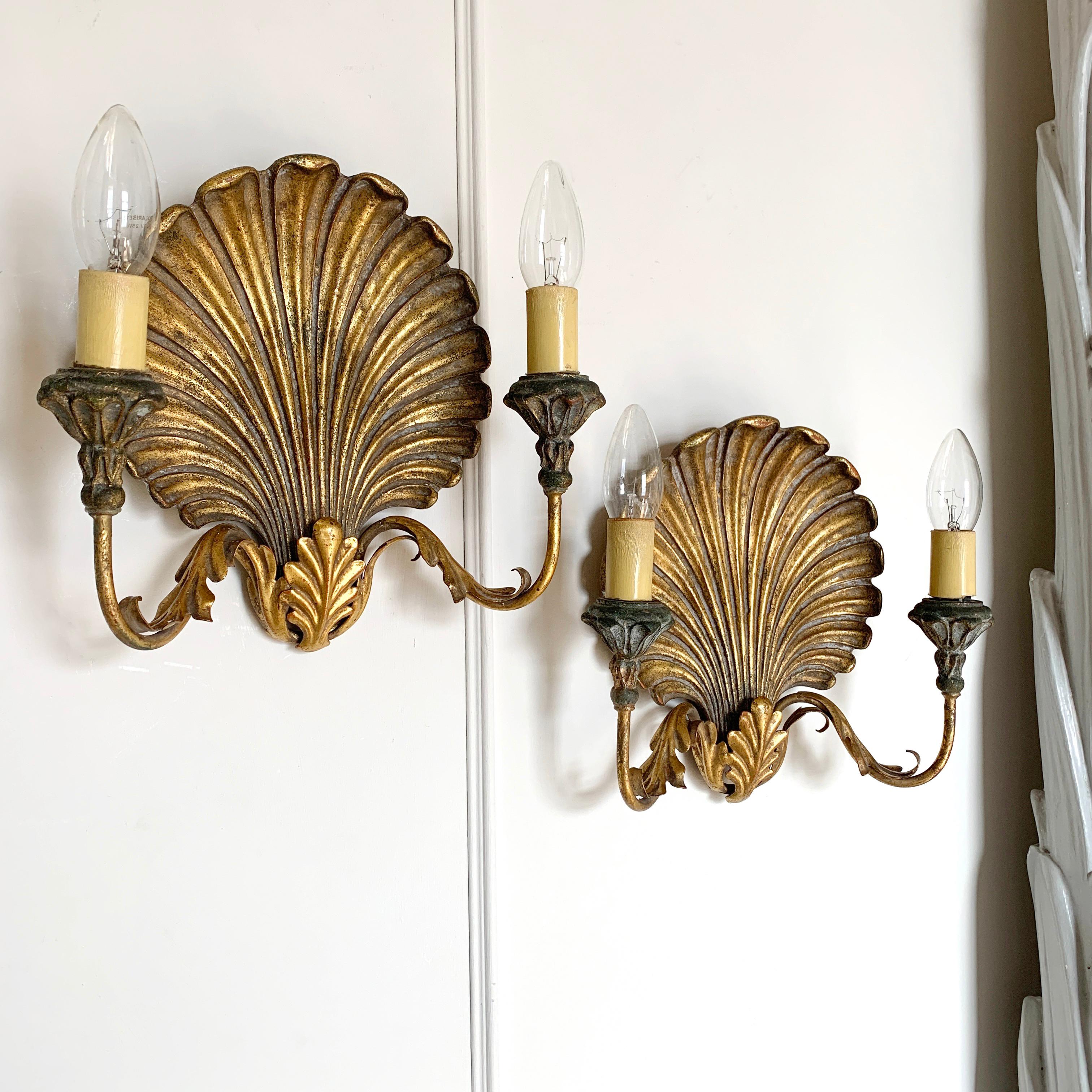 Palladio Italian shell wall lights, 1960's
A pair of gilt clam shell wall sconces
Metal arms with decorative metal acanthus leaf shaped details
Original Palladio sticker on the back dated mar 68
Decorative cups, each holding a single lamp