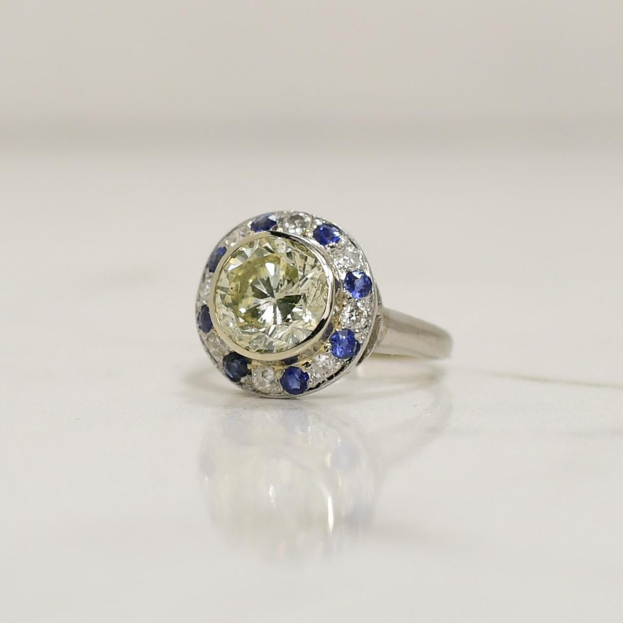 Crafted with elegance, the globe-shaped palladium Vintage Ring showcases a breathtaking union of 2.44 carats of dazzling diamonds and rich sapphires, evoking a timeless allure. The exquisite design, reminiscent of a celestial orb, features