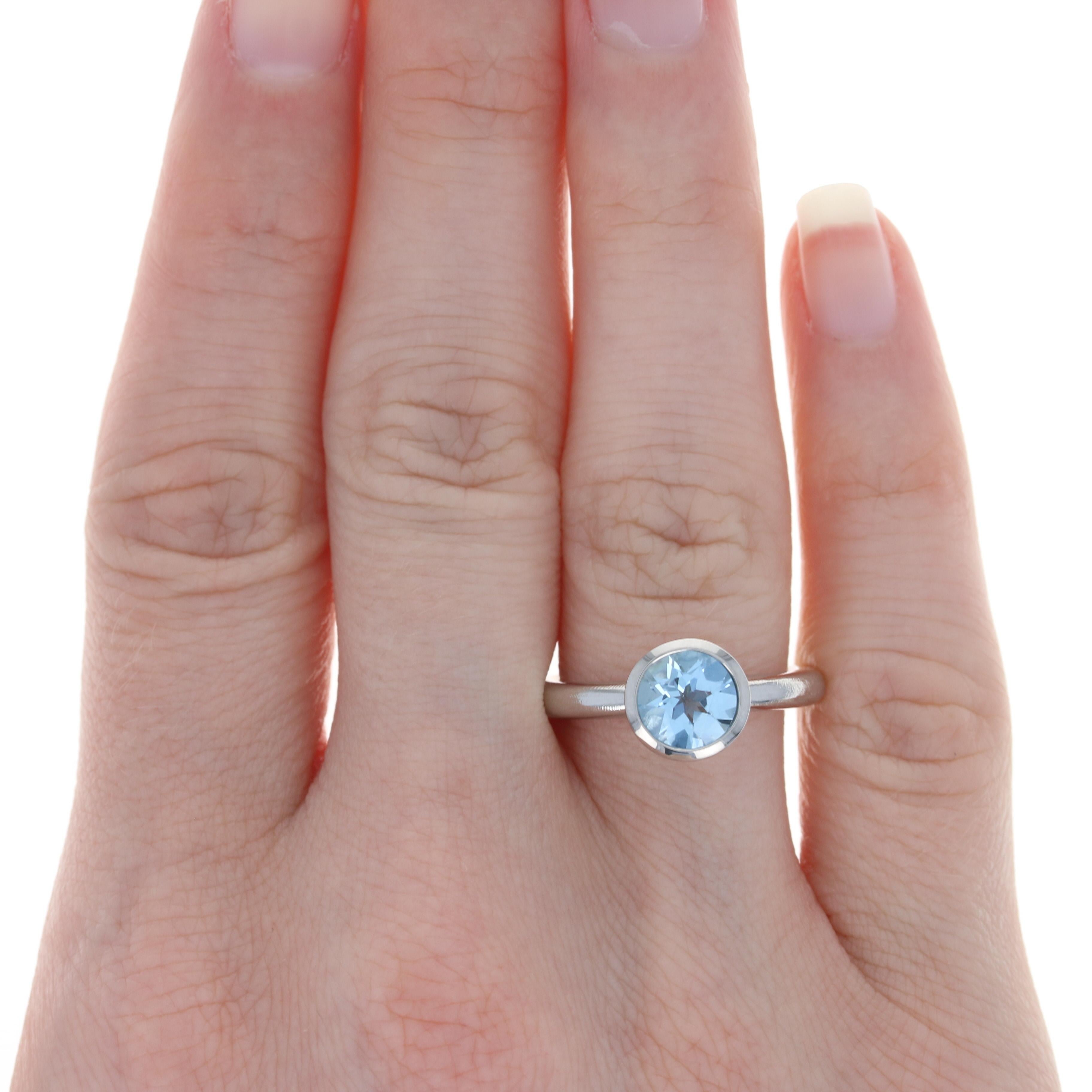 Size: 6 1/2

Metal Content: Palladium

Stone Information: 
Genuine Aquamarine
Treatment: Heating
Carat: 1.90ct
Cut: Round
Color: Blue 

Style: Solitaire
Features: Brushed & Smooth Finishes

Face Height (north to south): 11/32