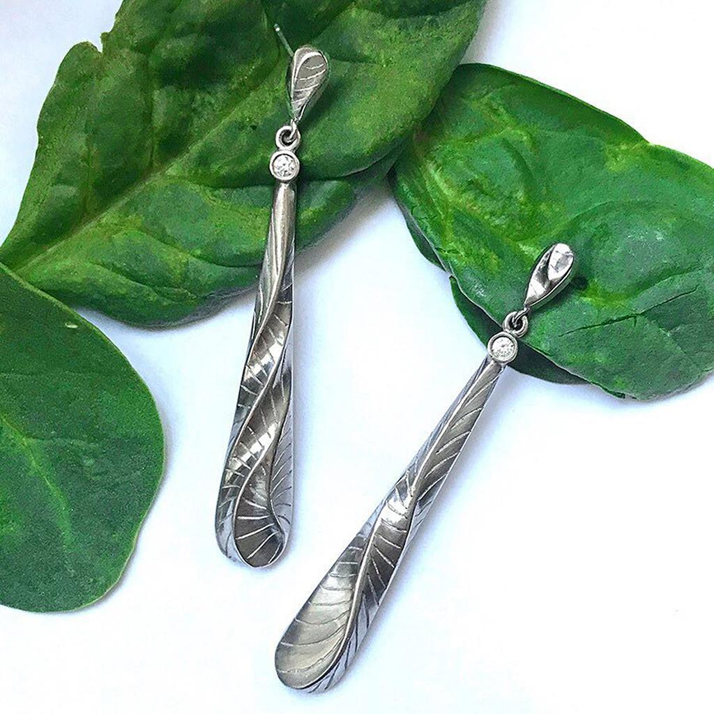 Keiko Mita's Long Tear Drop Earrings, which are handmade from Palladium and feature her signature Dune texture, are 62 mm long and 9 mm wide. The contemporary earrings are accented with Diamonds (0.10 Carats total weight). 

