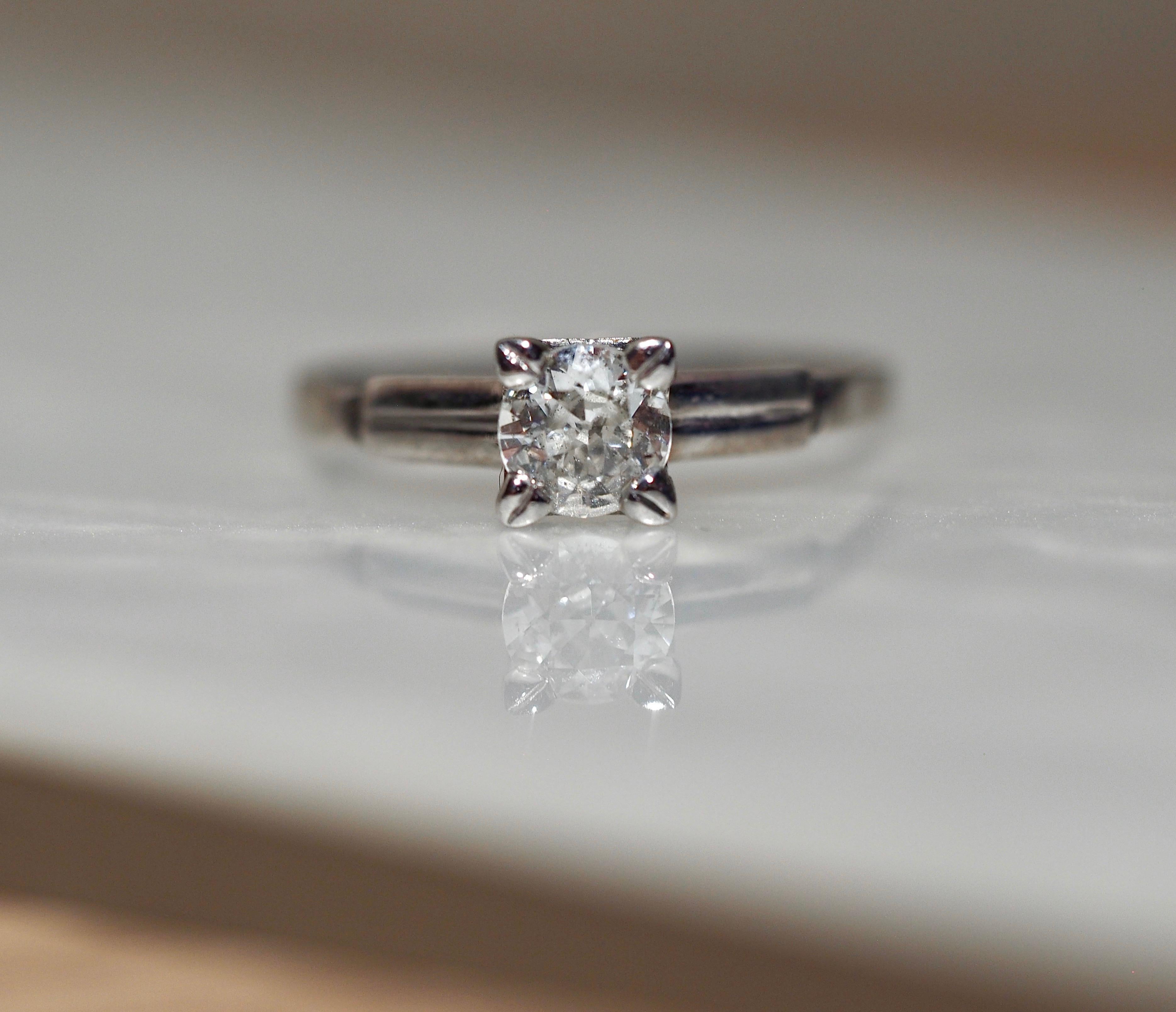 This lovely palladium vintage solitaire engagement ring features an Old European Cut Diamond set in four prongs, weighing .41 carats I1 in clarity I in color.  Shank tapers from 5.64 - 1.19 mm.  Finger size 6.75 and can be sized up or down prior to