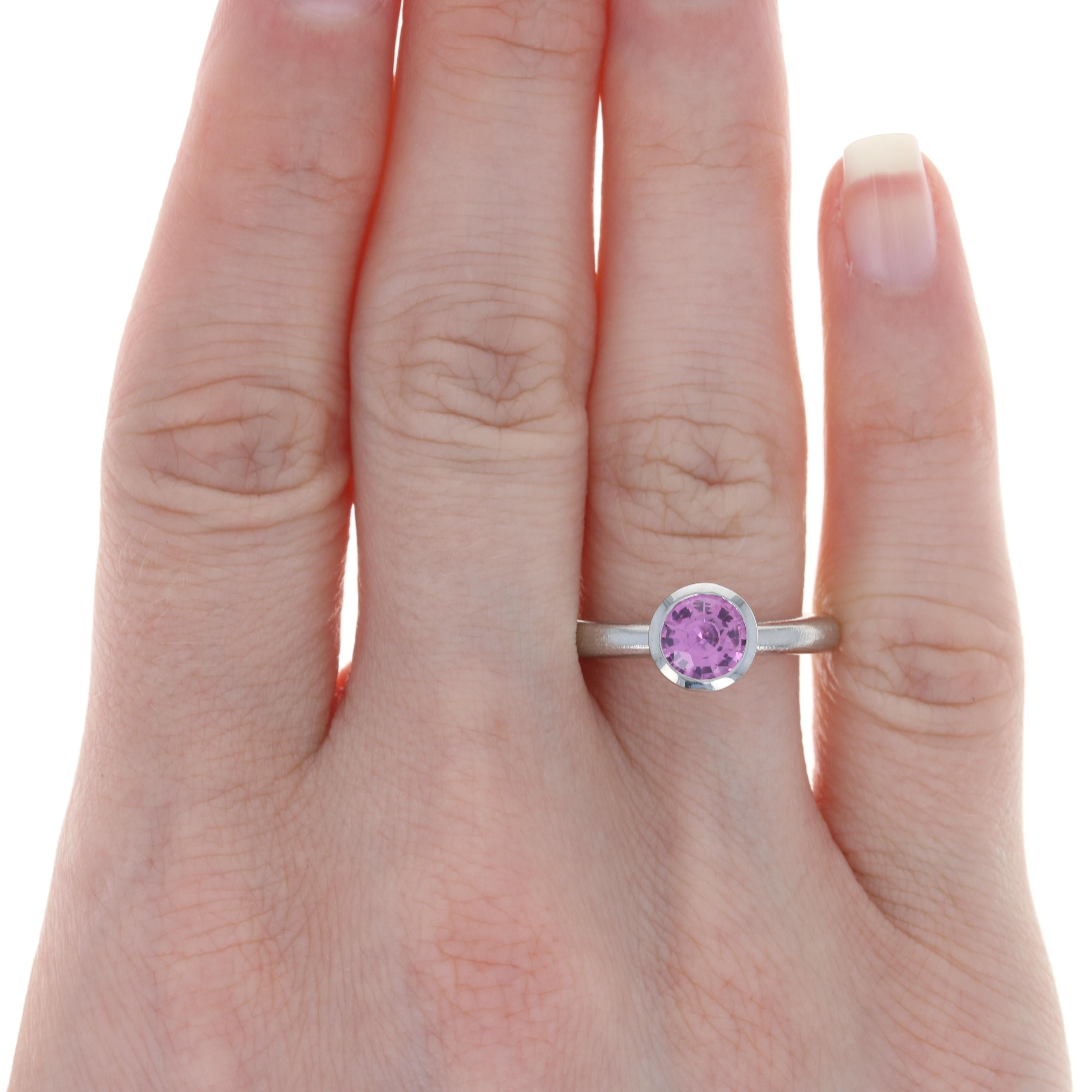 Size:  6 3/4

Metal Content: Palladium

Stone Information: 
Genuine Sapphire
Treatment: Heating
Carat: 1.40ct
Cut: Round
Color: Pink

Style: Solitaire 
Features: Brushed & Smooth Finishes

Face Height (north to south): 5/16