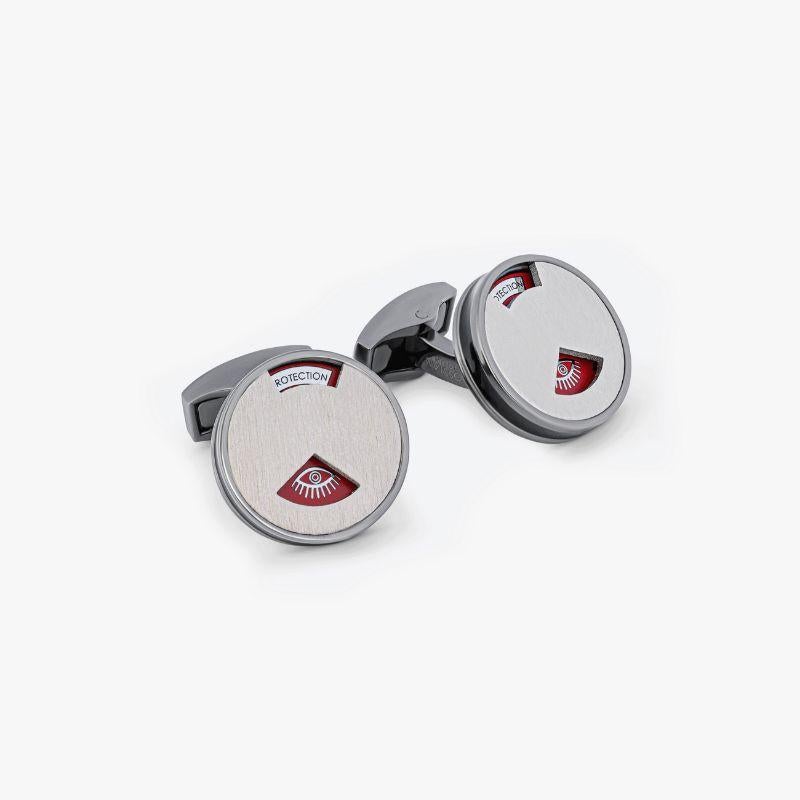 Palladium Plated Talismanic Window Cufflinks with Red Enamel

These fun novelty cufflinks feature a rotating brushed palladium top with windows that can be spun to reveal symbols and words carved in metal. These pieces are set into a layer of