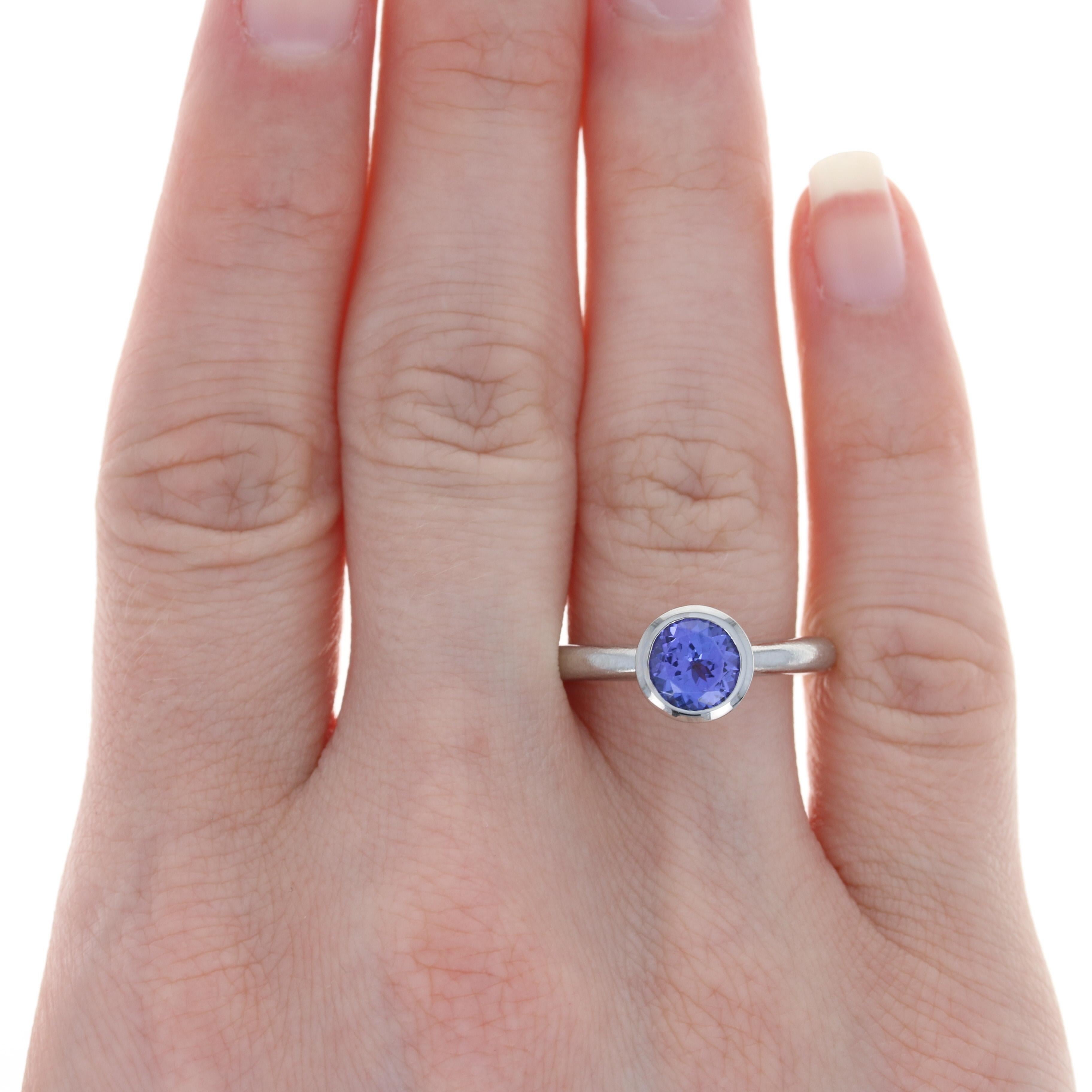 Size: 7

Metal Content: Palladium 

Stone Information: 
Genuine Tanzanite
Treatment: Routinely Enhanced
Carat: 1.60ct
Cut: Round
Color: Purple

Style: Solitaire
Features: Brushed & Smooth Finishes

Face Height (north to south): 11/32