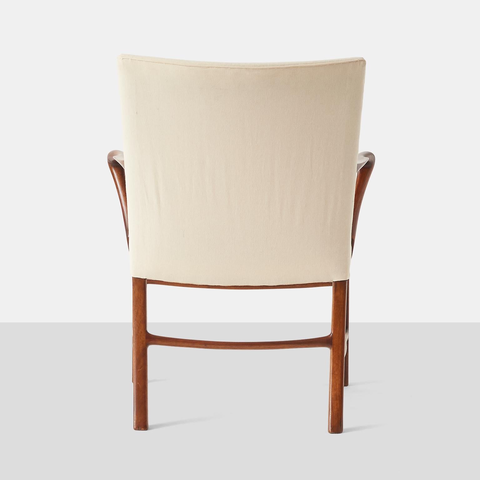 A pair of armchairs attributed to Palle Suenson. Constructed from nutwood with elegantly curved arms. Seat and back have been recovered in a simple cotton fabric.

Measure: Arm Height: 25