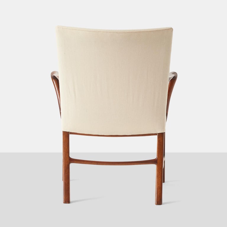 A pair of armchairs attributed to Palle Suenson. Constructed from nutwood with elegantly curved arms. Seat and back have been recovered in a simple cotton fabric.

Measure: Arm Height: 25