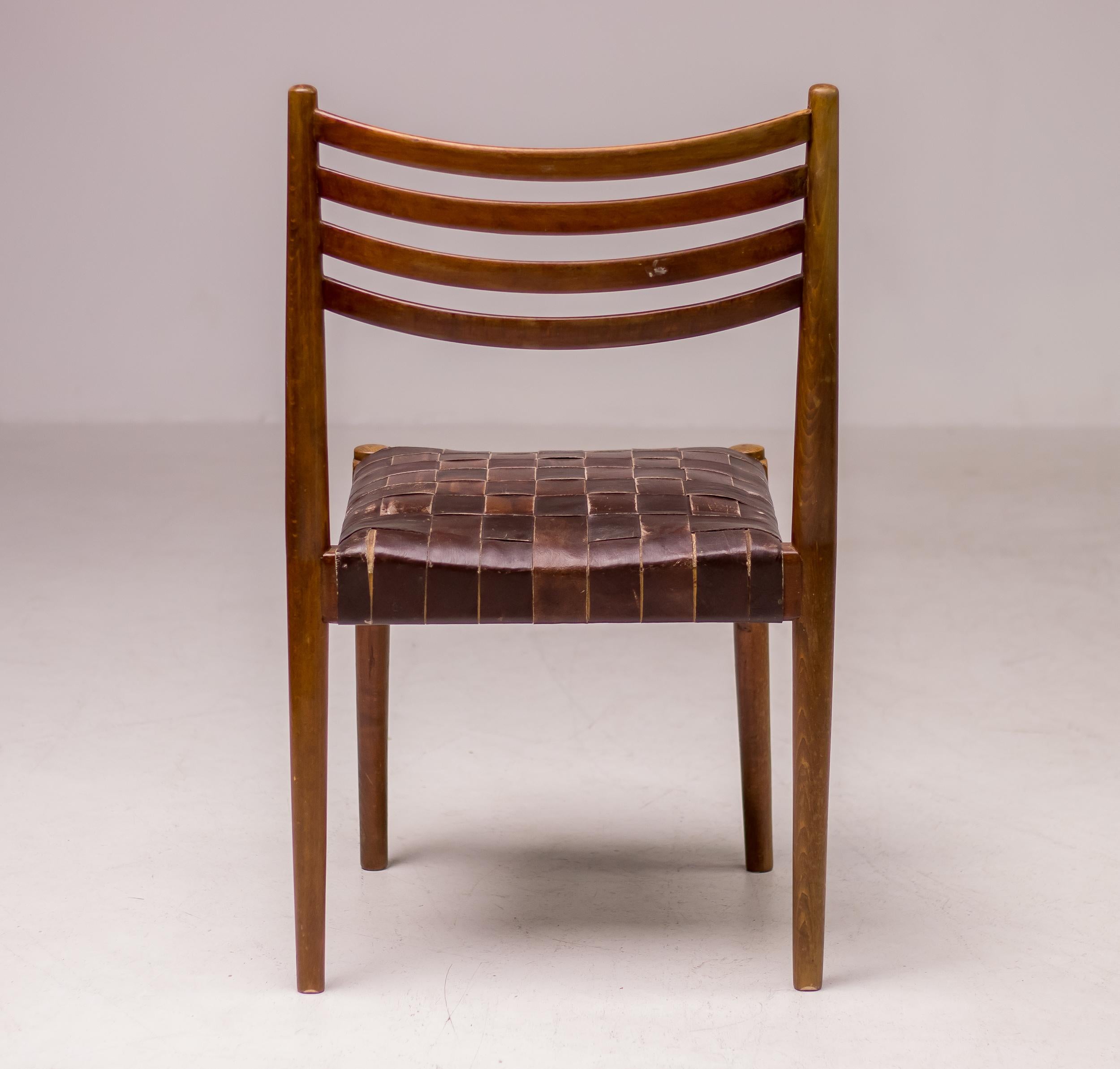 Dark stained beech chair with a webbed leather seating. The chair is attributed to Palle Suenson, as they come from the office building of the Aarhus Oliefabrik (1938-1942), which was designed and furnished by Suenson. 
The chair is in beautiful all