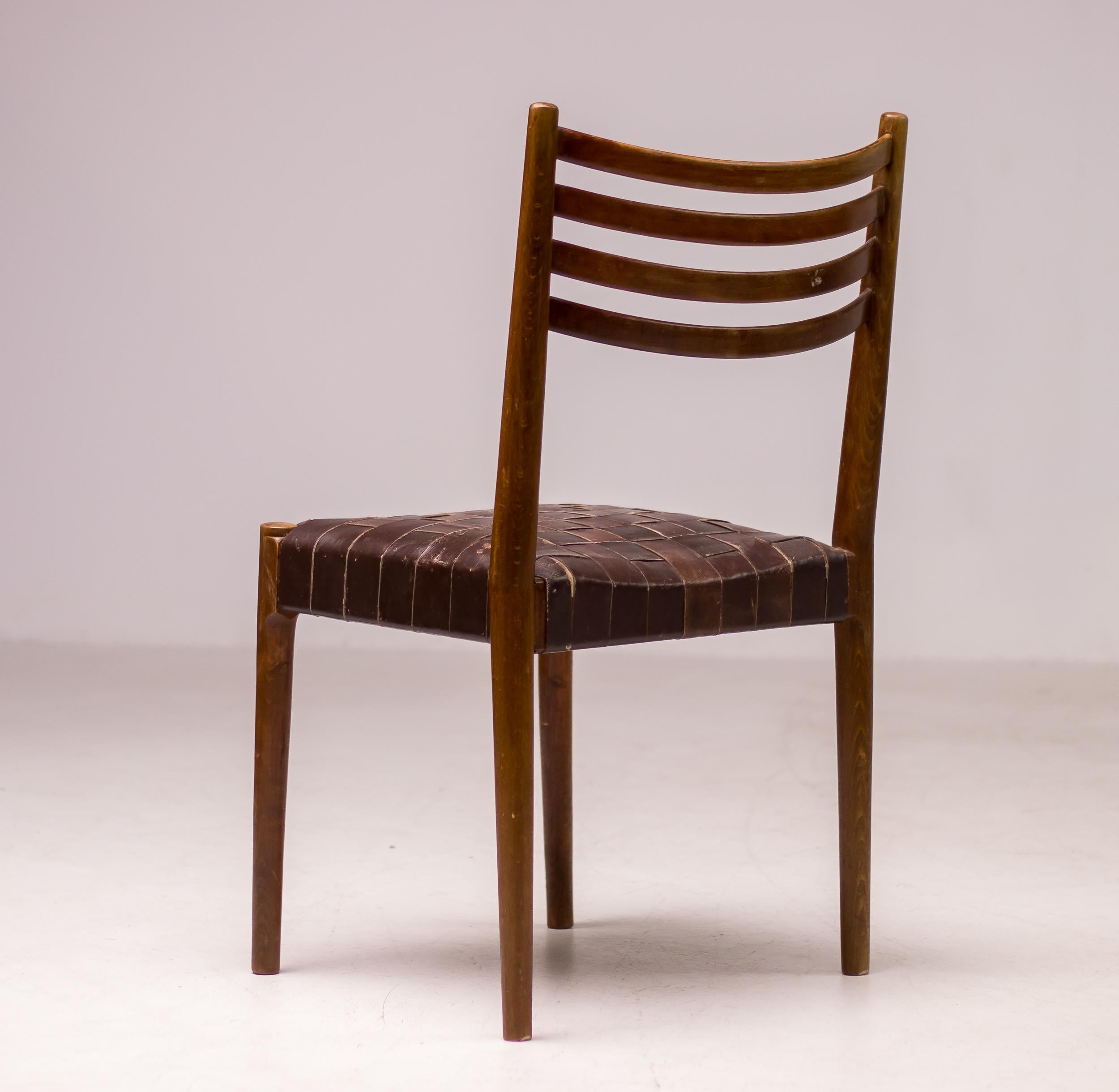 Dark stained beech chair with a webbed leather seating. The chair is attributed to Palle Suenson, as they come from the office building of the Aarhus Oliefabrik (1938-1942), which was designed and furnished by Suenson. 
The chair is in beautiful all