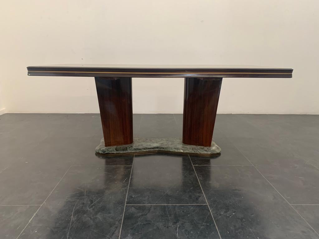 Rosewood table with glass top and green alpi marble base by Vittorio Dassi For Dassi, 1950s.
Rosewood table designed by Vittorio Dassi in the 1950s. The top has a flared frame with a gold profile in the center; it surrounds a bronzed glass. The
