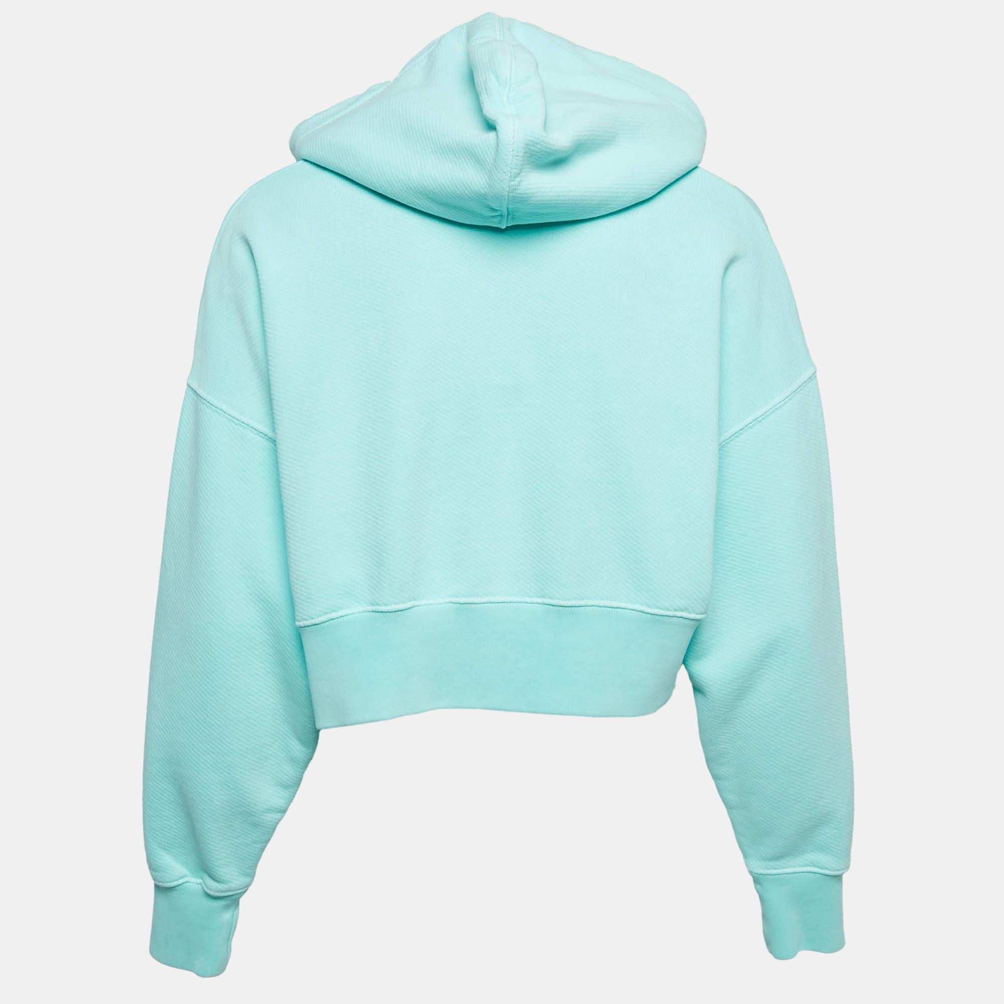 Abbraccia le vibrazioni rilassate con la felpa Palm Angels Seafoam Green Cotton Crop Hoodie. Caratterizzata da una stampa che abbraccia le palme, questa felpa con cappuccio unisce comfort e stile senza sforzo. La sua vestibilità cropped e la sua