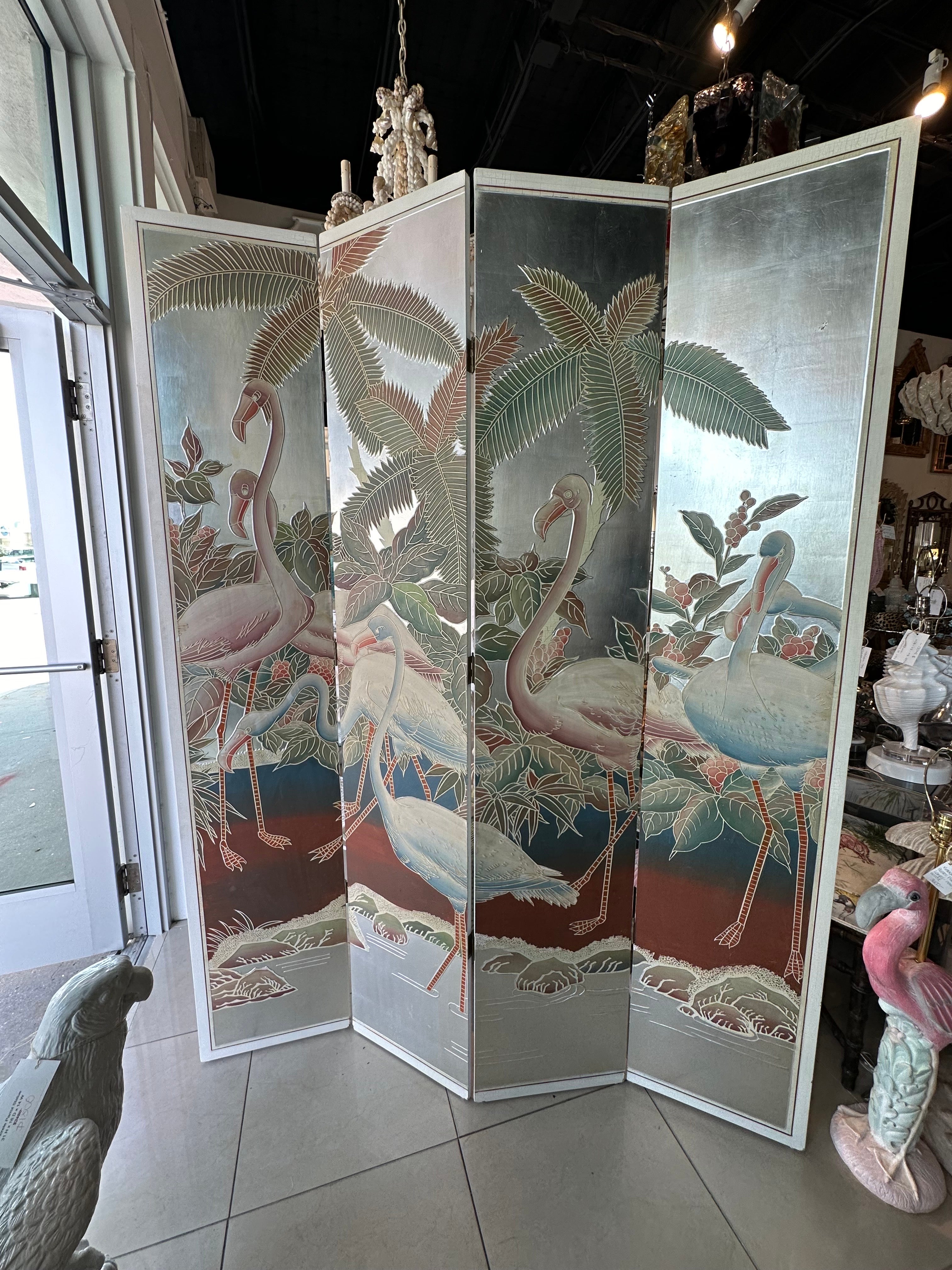 The most beautiful 1940s hand-painted 4 panel folding screen room divider, silver leaf background. Perfectly Palm Beach with palm trees and flamingos. Back is solid color. Excellent condition with one small mark on silver leaf, pictured. Dimensions: