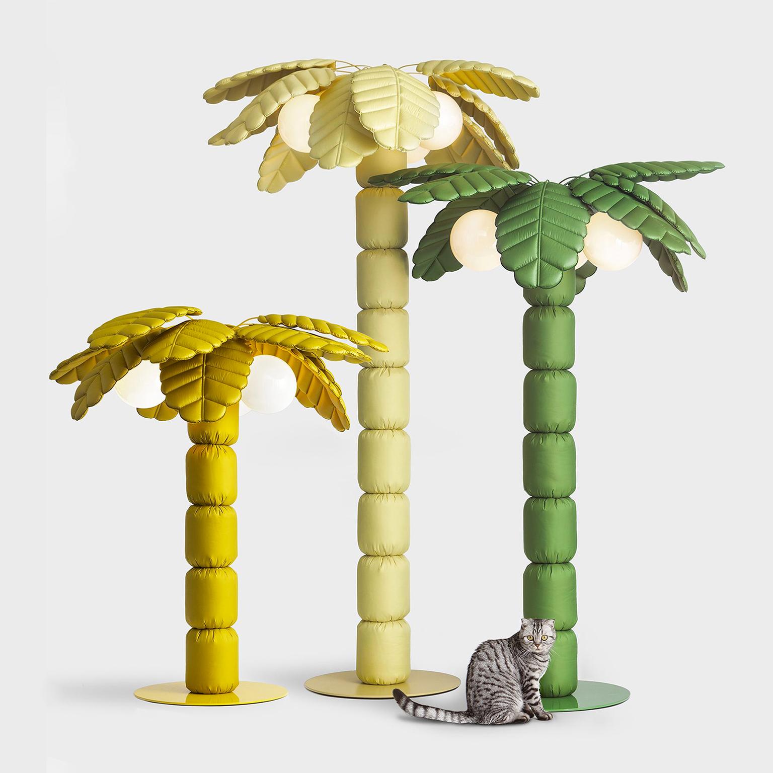 Padded standing light with painted steel structure. N°3 glass light bulbs 12 W, 2700 K and fabric wire. Palm Beach is a soft palm tree with crazy coconuts that double as lights. Palm Beach comes in a series of bright and neutral colors, and it’s