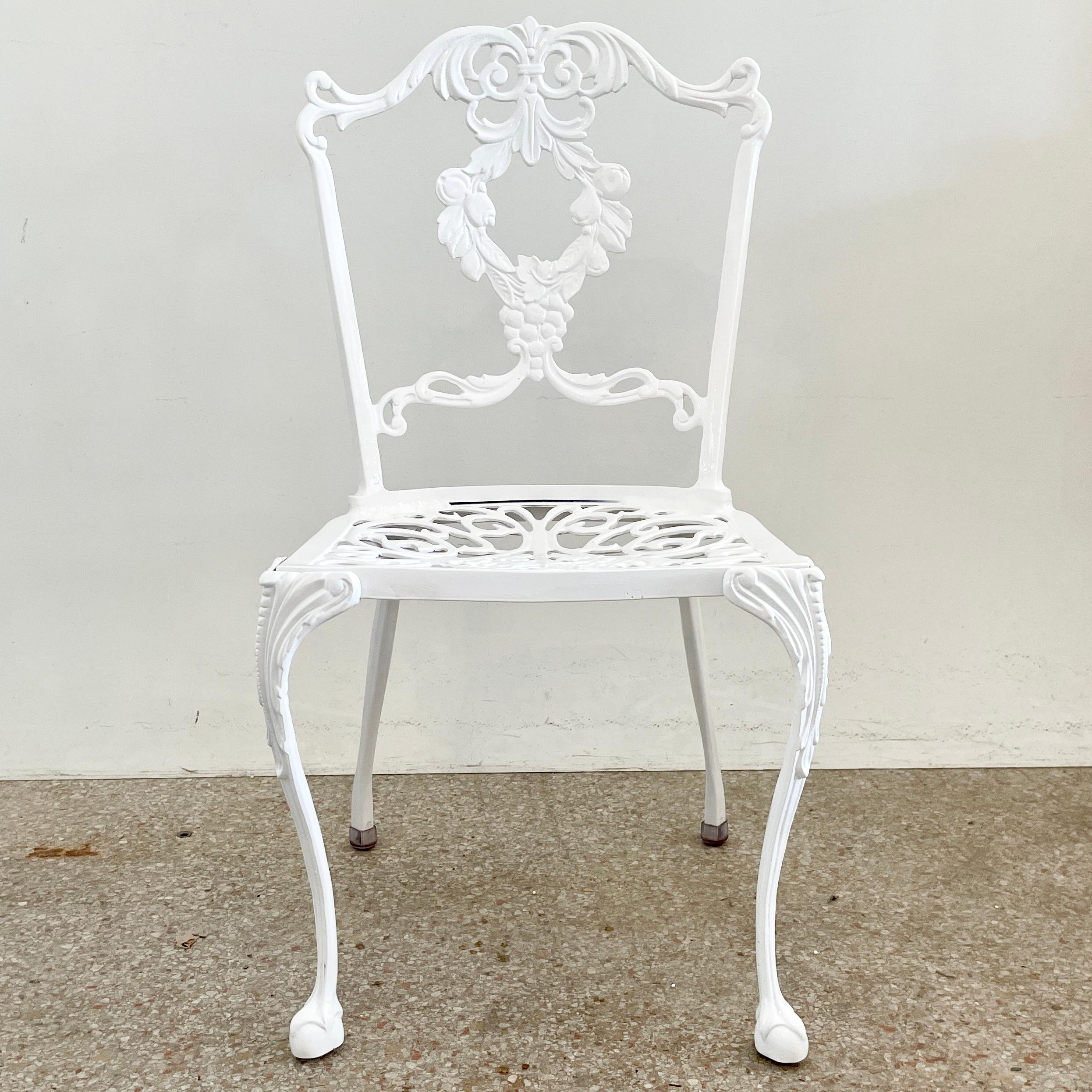 Palm Beach Regency patio dining chair freshly lacquered white. The details on the seat are amazing, see the pictures. Add some classical elements to your patio with these architectural chairs. We have three chairs available plus many more Palm beach