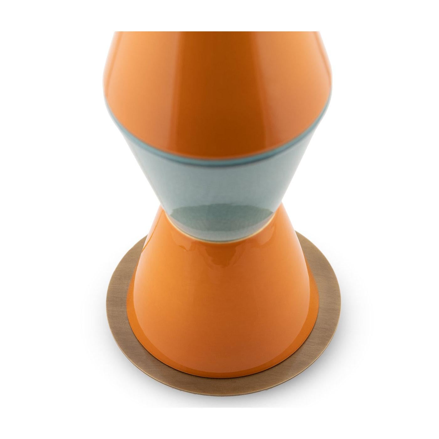 A splendid combination of minimalist and sculptural design, this table lamp is distinguished by an eye-catching silhouette of strong geometric value. Composed of five truncated cone elements fashioned of aquamarine and orange-glazed ceramic, it