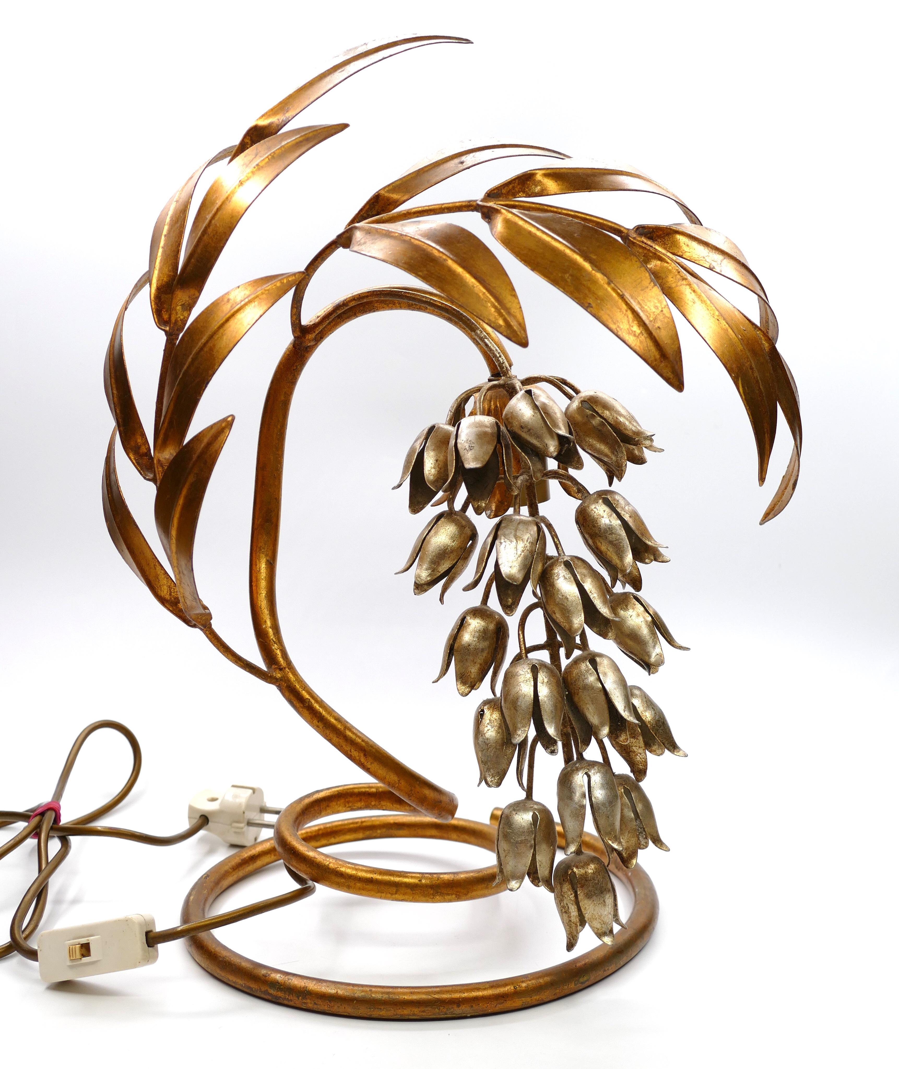 Wisteria table lamp is an original design lamp realized by the German designer Hans Kögl, circa 1970s.

Iconic table lamp made of silver and gold-plated metal.

Hans Kögl became famous as a lightning designer creating huge gilt metal lamps with a