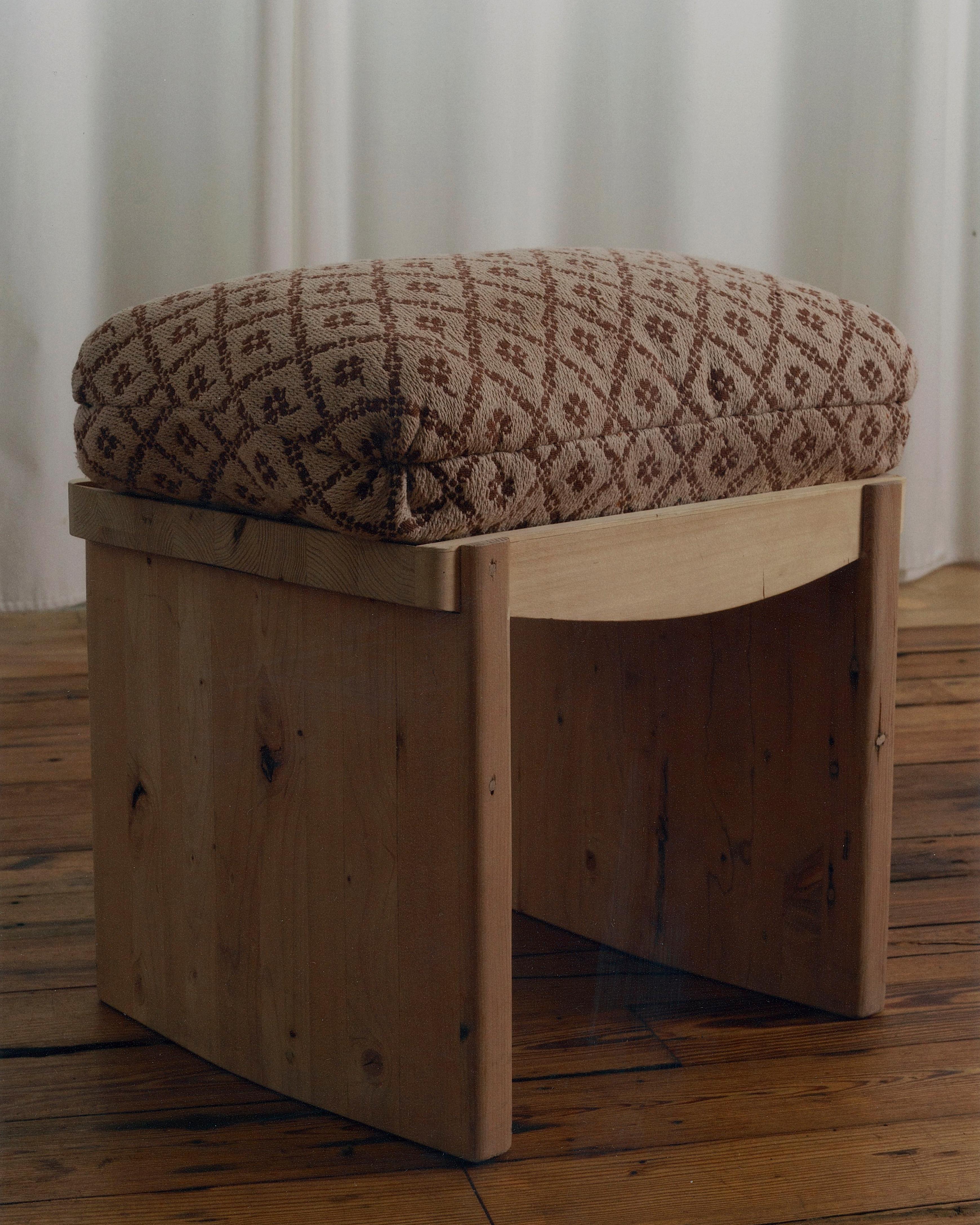 Made entirely of solid hardwood, every component is shaped and finished by hand. The carved seat has a gentle interior curve, with a Turkish corner cushion placed within the recess. 
Available in Rustic Oak & Walnut and Vintage fabric. This item is