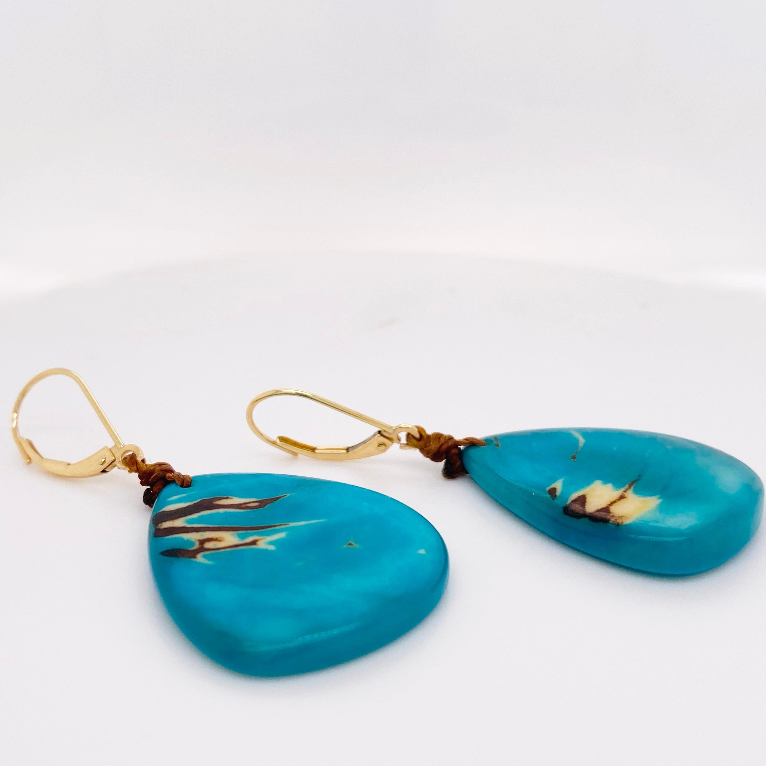 These turquoise nut dangle earrings are perfect with the current fashions. The earring leverbacks are solid 14 karat yellow gold and the dangle is a palm tree nut from the Ecuador rainforest and is eco-friendly and sustainable. The nut has been hand