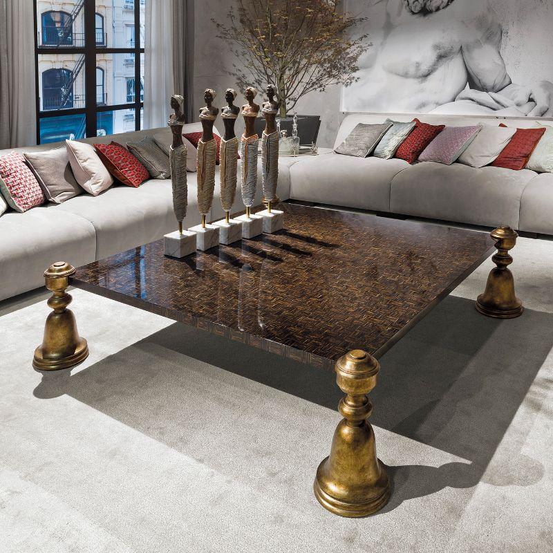 A stately and extraordinarily lavish design, this magnificent coffee table will not go unnoticed in any decor style. Sculptural yet clean in character, it features a precious palm wood top and rests on bell-shaped wooden legs finished with fine gold
