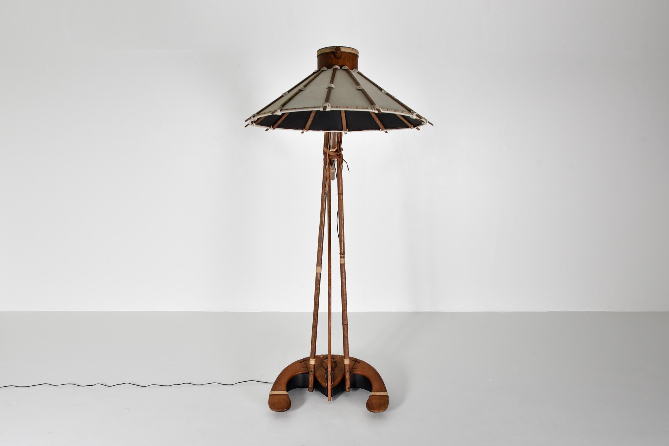 Ethnic inspired huge floor lamp by an unknown artist, Europe, 1990s

The craft and materials used are high-end. 
Solid palm wood sticks bound together with rope and leather strings provide an ethnic and primitive feel.
Don't be fooled by the