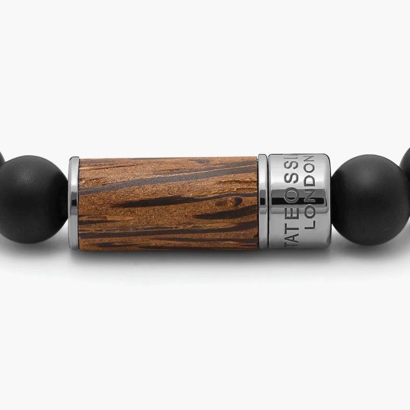 Palma Nera Bracelet in Palma Nera Wood with Black Agate, Size L

Natural dark palm wood contrasts seamlessly with the frosted finish of each black agate bead. Finished in a black rhodium plated sterling silver pop clasp, meticulously engineered in