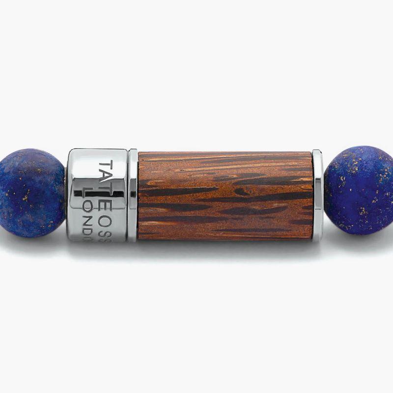 Palma Nera Bracelet in Palma Nera Wood with Lapis, Size L

Natural dark palm wood contrasts seamlessly with the frosted finish of each lapis bead. Finished in a black rhodium plated sterling silver pop clasp, meticulously engineered in our Italian