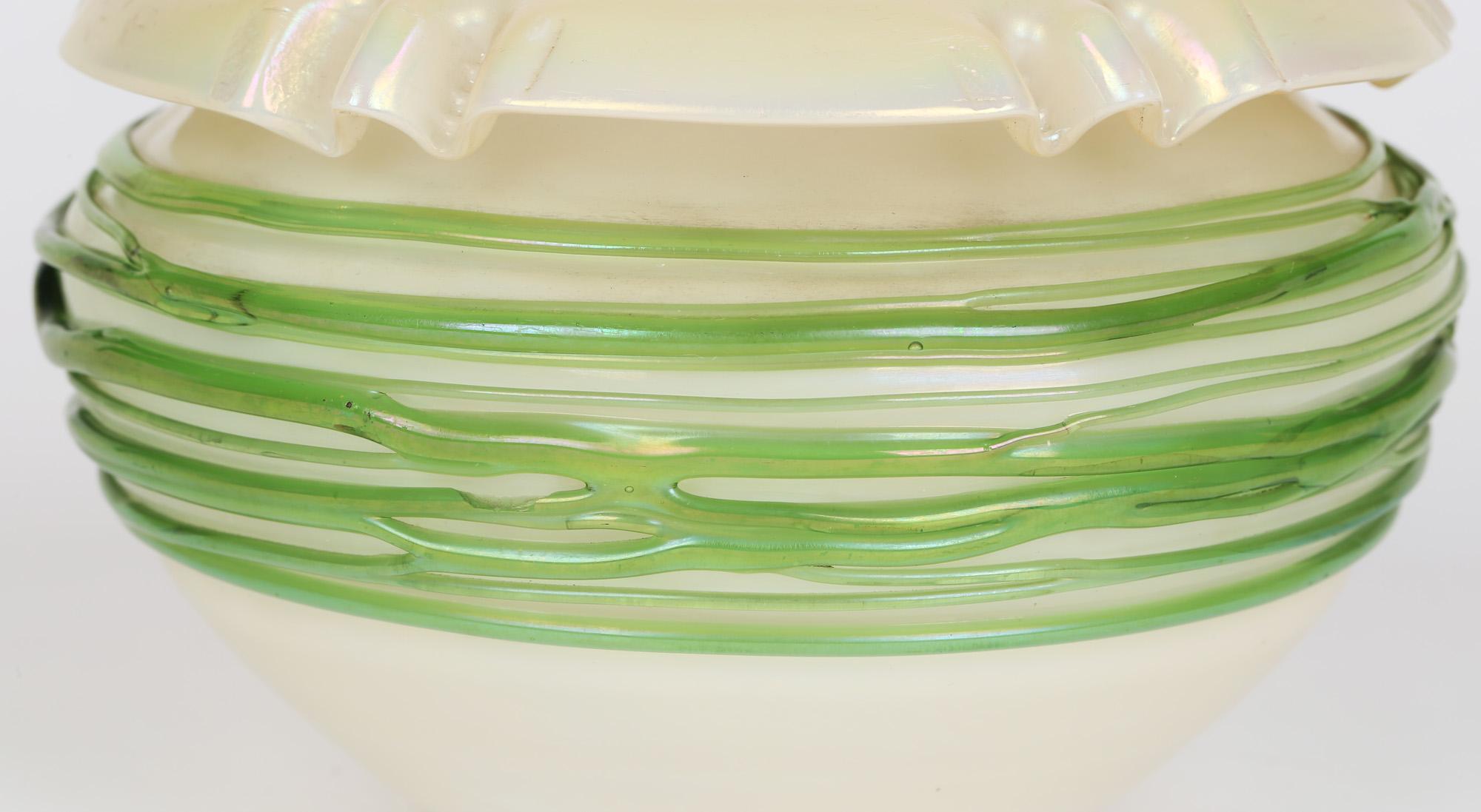 A stunning Art Nouveau iridescent glass vase applied with green trailed thread patterning attributed to Palme König and dating from the early 20th century. The origins of this stunning piece have been disputed however we believe it is of Bohemian