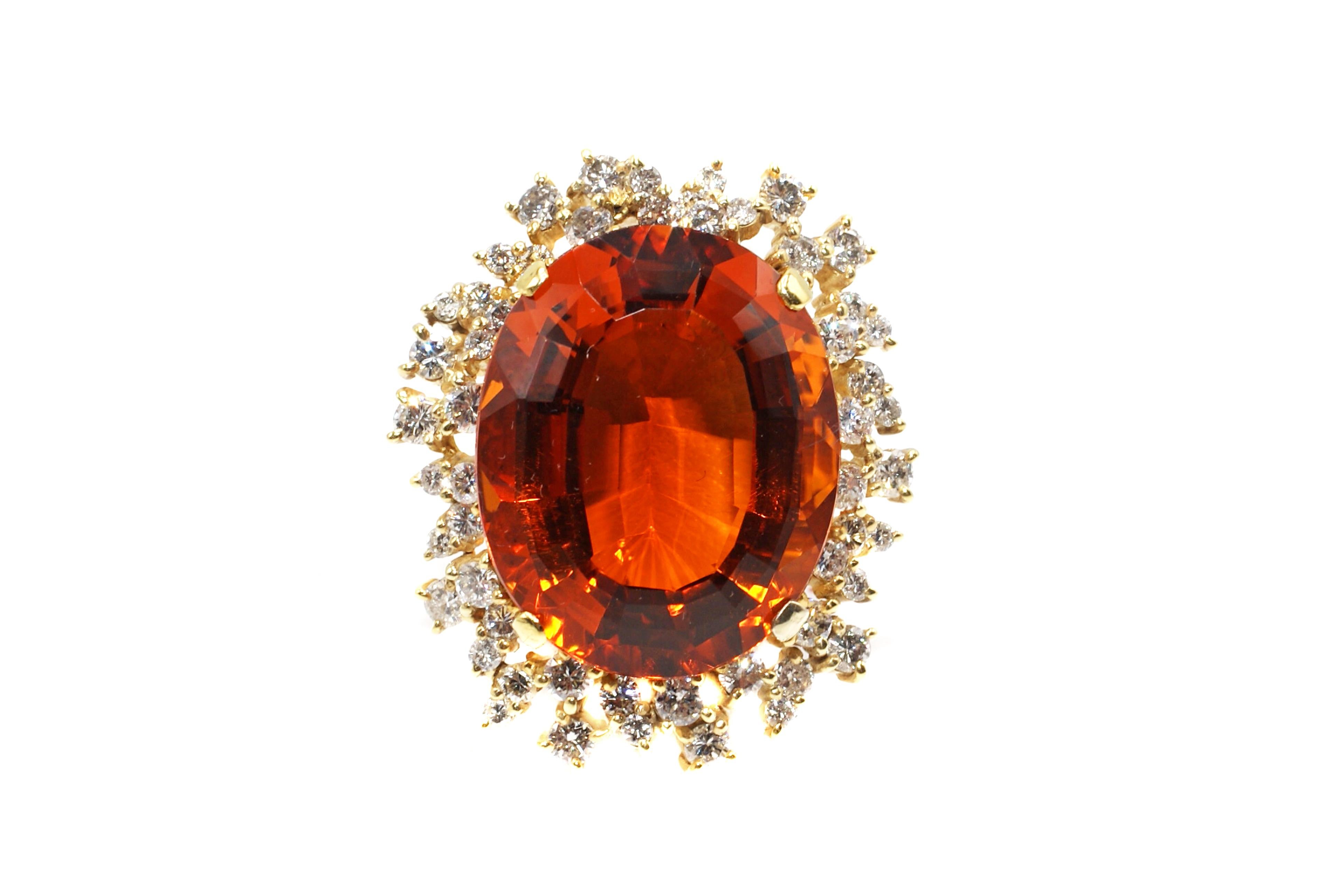 This unique and abstract handcrafted ring features a stunning oval faceted Palmeria Citrine measured to weigh over 50 carats. This amazingly well cut gemstone exhibits a wonderful orange color with fantastic life and brilliance. Surrounding the