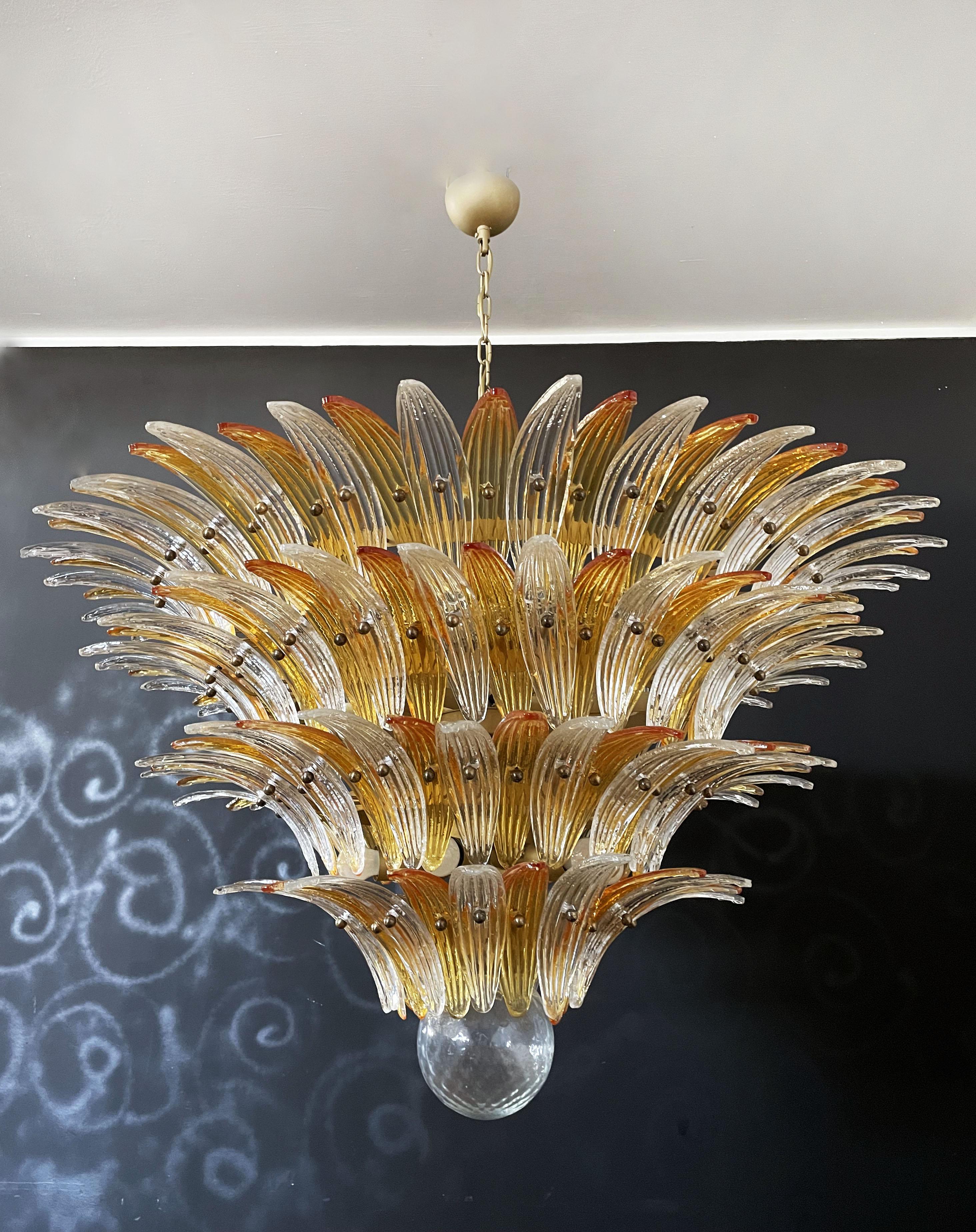 Palmette ceiling light made by 163 Murano amber and trasparent glasses in a gold metal frame. Murano blown glass in a traditional way. Structure in gold colored metal.
Period: 1980's.
Dimensions: 55,10 inches (140cm) height with chain; 31,50