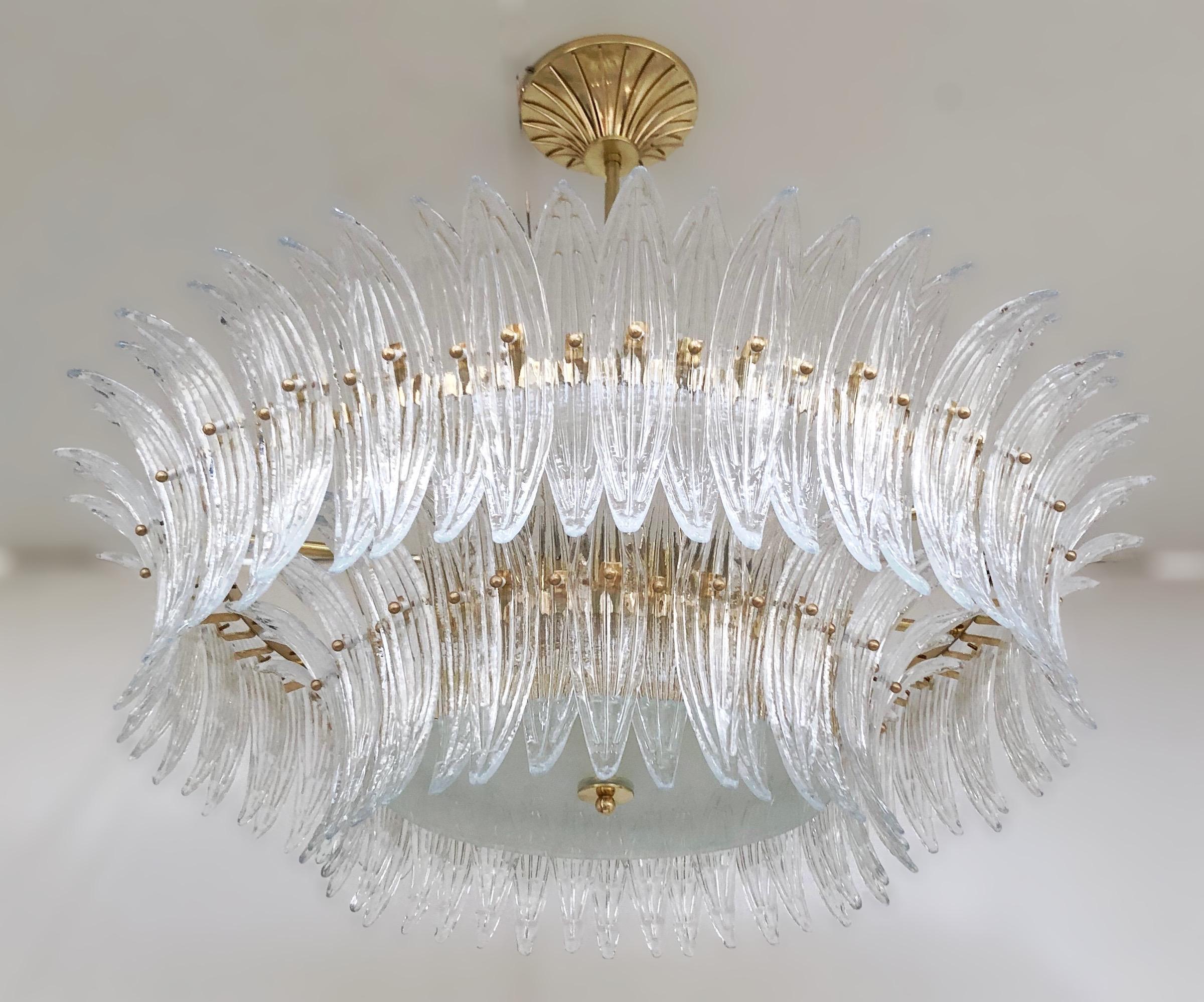 Italian Palmette chandelier shown in clear Murano glass leaves mounted on unlacquered natural brass finish frame with a frosted glass diffuser / Made in Italy
Diameter 39.5 inches, height 13 inches, total height 35.5 inches including rod and