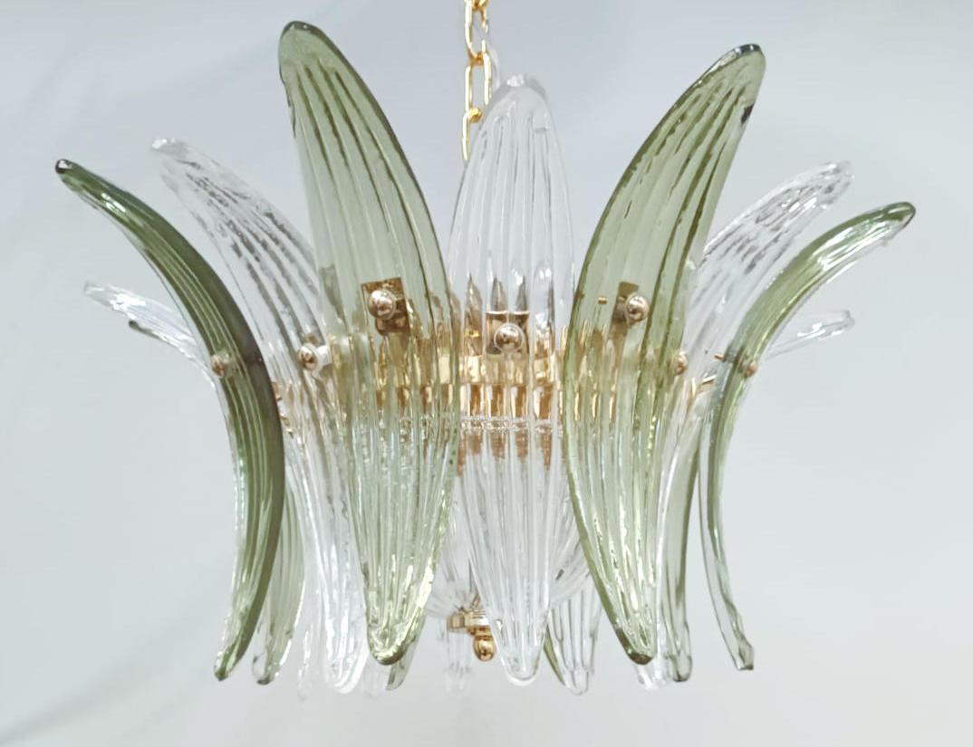 Italian Palmette chandelier shown in clear and green Murano glass leaves, mounted on 24k gold plated metal finish frame / Made in Italy.
4 lights / E12 or E14 type / max 40W each
Diameter: 18.5 inches / Height: 11 inches
Order Only / This item ships