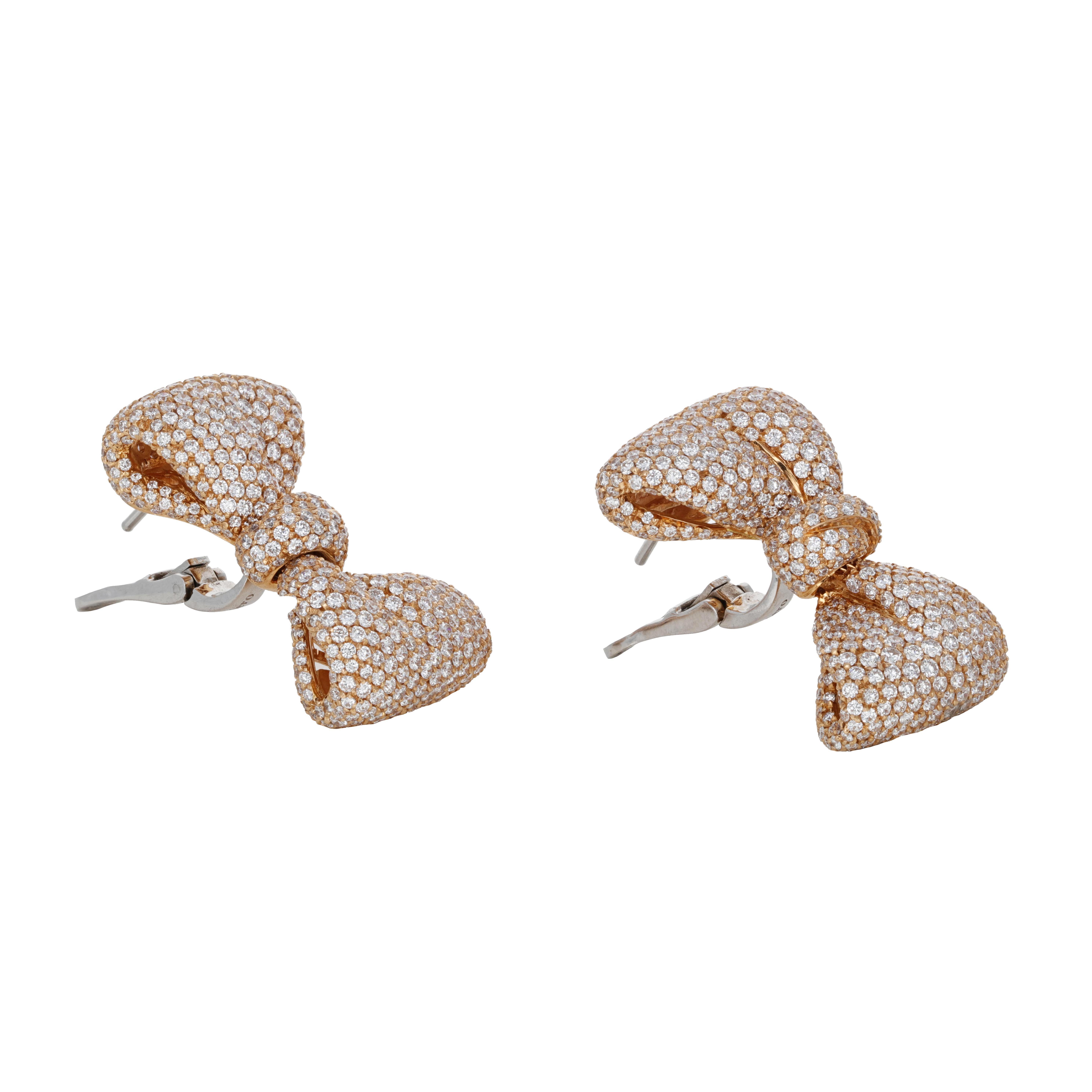 These 18 karat yellow gold diamond bow earrings are signed by the Italian designer Palmiero. These earrings have a lever back and drop from the ear very nicely. 

There is a total weight of 9.48 carats in round brilliant diamonds.

Signed Palmiero
