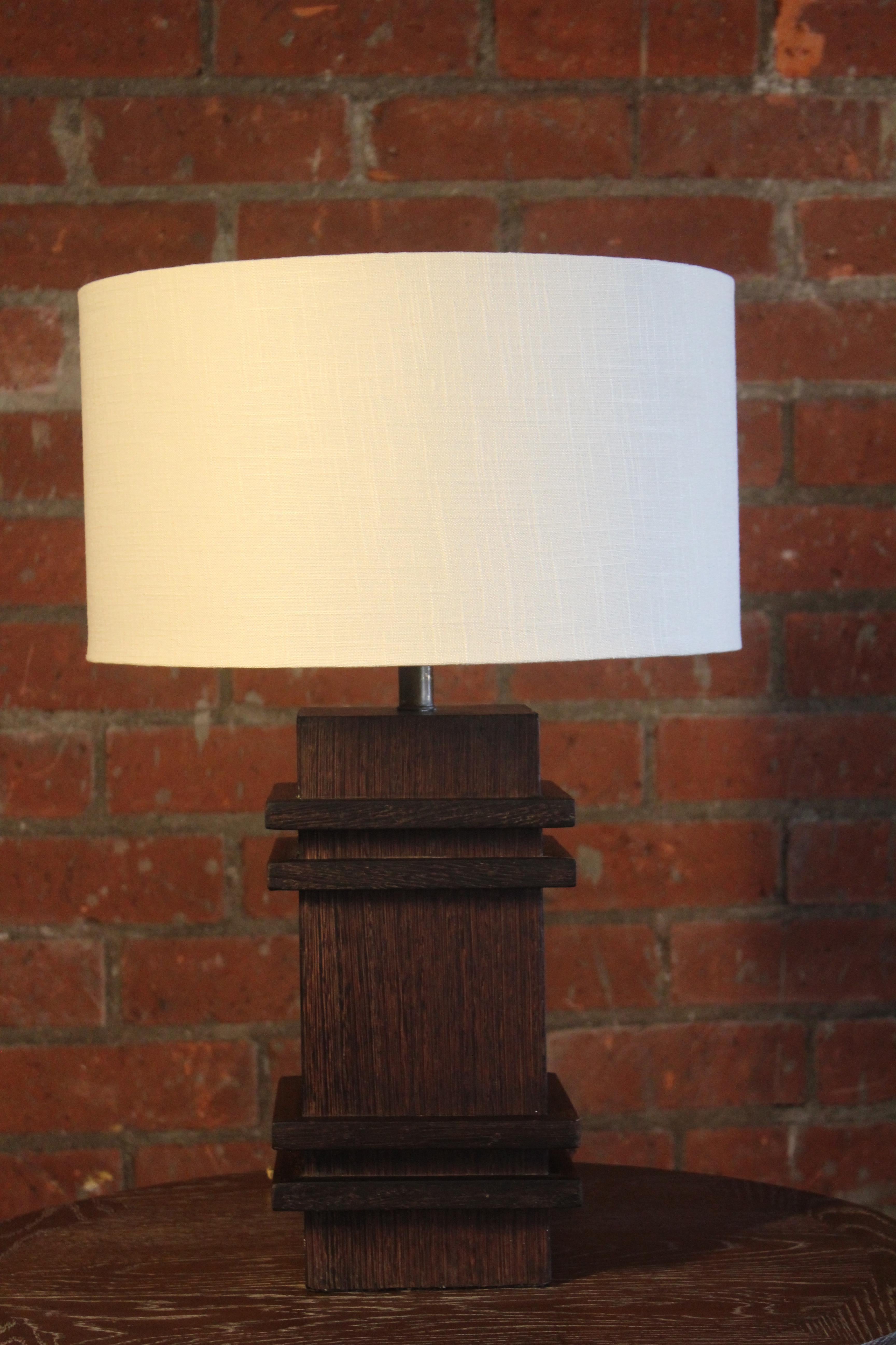 A rare table lamp in palmwood attributed to Jacques Adnet, France, 1940s. This lamp has been rewired for U.S standards and fitted with a custom linen shade.
The lamp itself is 7