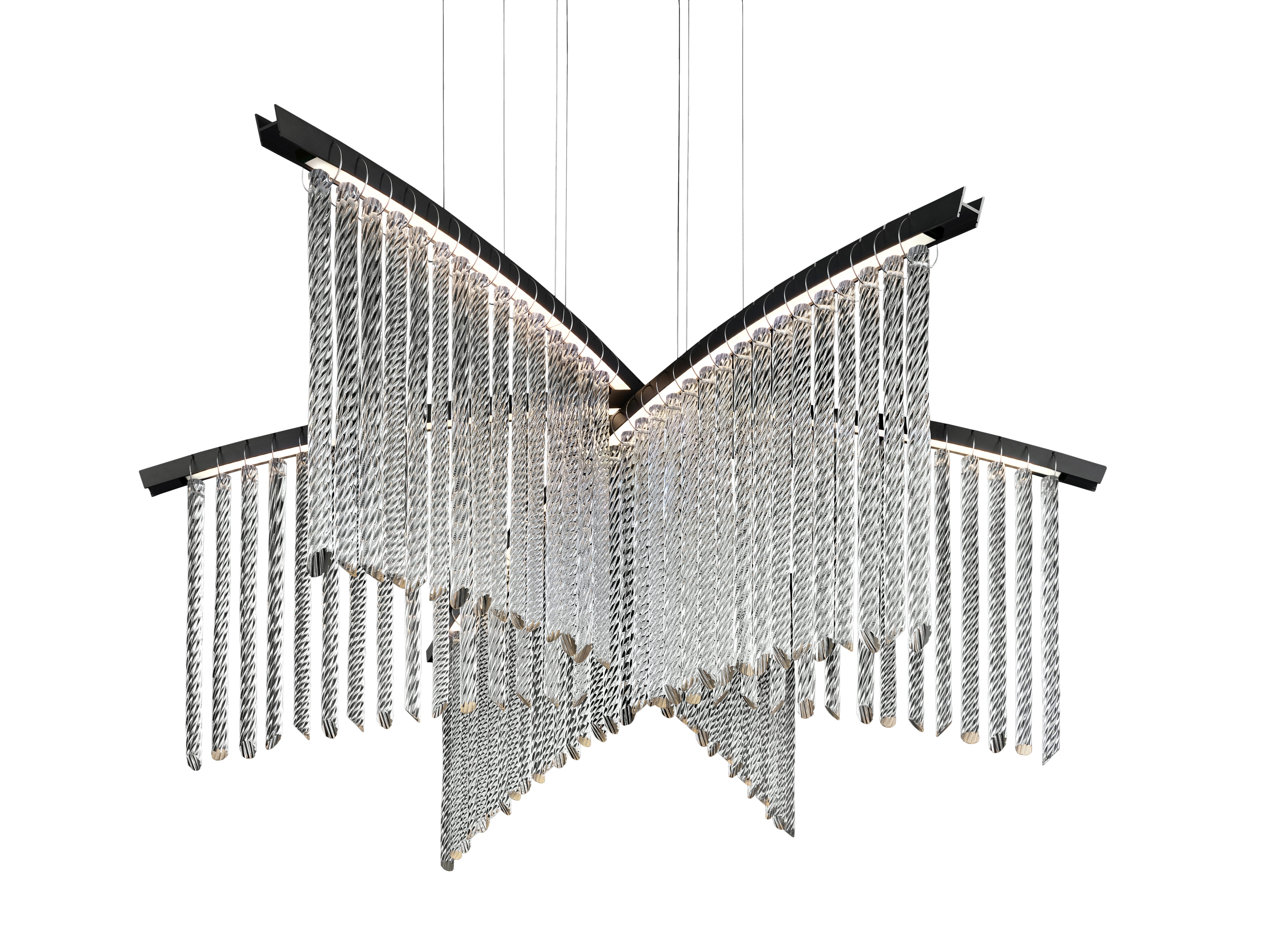 Palmyra is a very light chandelier, characterized by a sinuous line, able to embellish and illuminate any environment with its LED technology. Here you are shown the Palmyra 7274 Suspension Lamp in Crystal Glass with an Anodized Black finish and