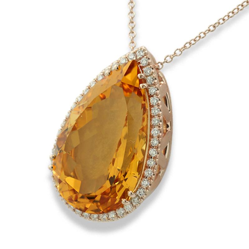 Impressive pendant featuring a very large citrine, approx. 27.46 carats, cut in a pear shape with facets. The gemstone exhibits a deep, intense orange-yellow hue, commonly referred to as Palmyra Citrine. The voluminous gemstone is meticulously cut,