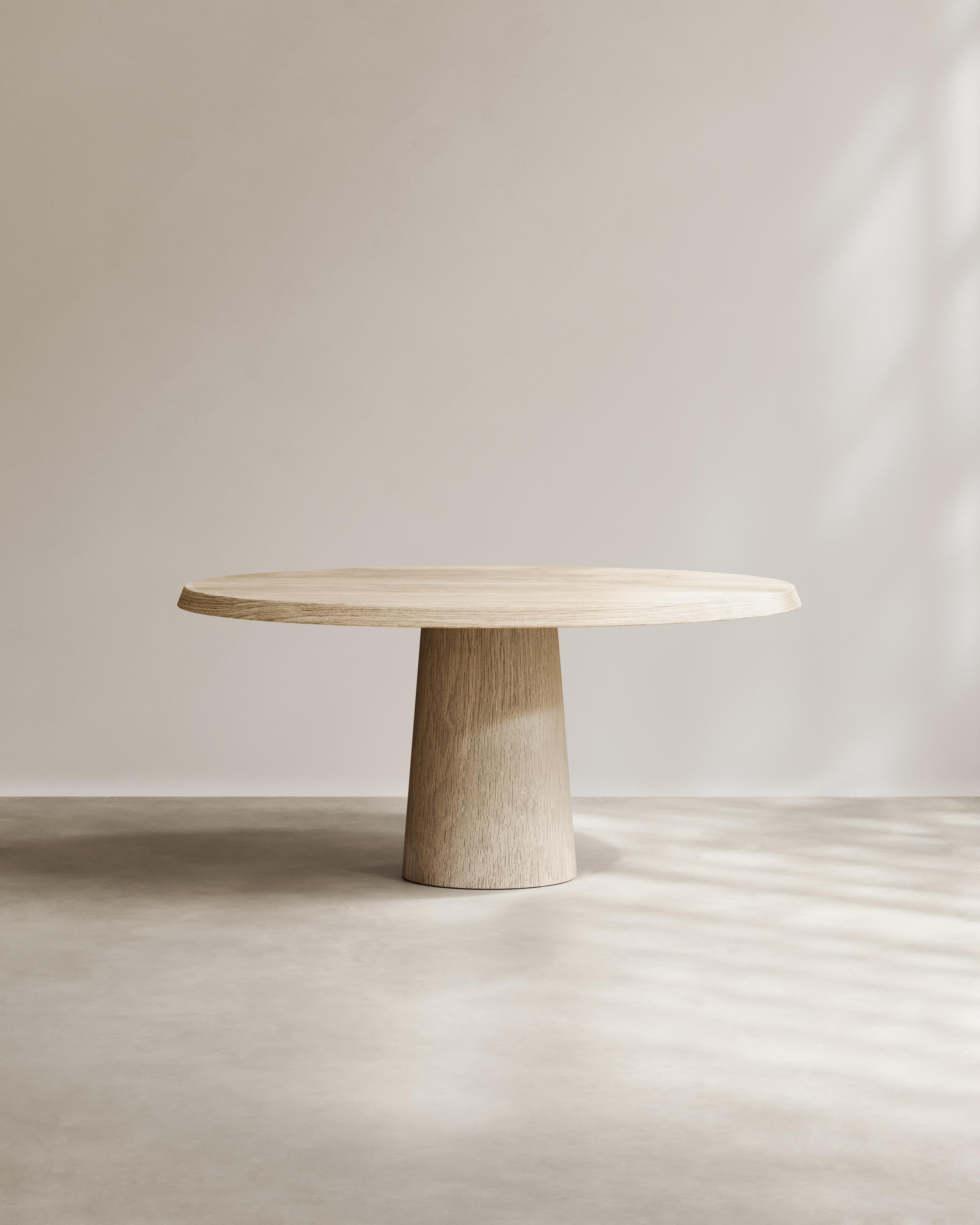 The Domus Table by Paloma Editions is handmade in Italy. Sculpted from solid French oak, it balances monumental presence with graceful proportion: a radial base rises to a smooth circular top, marrying architectural discipline with natural warmth.