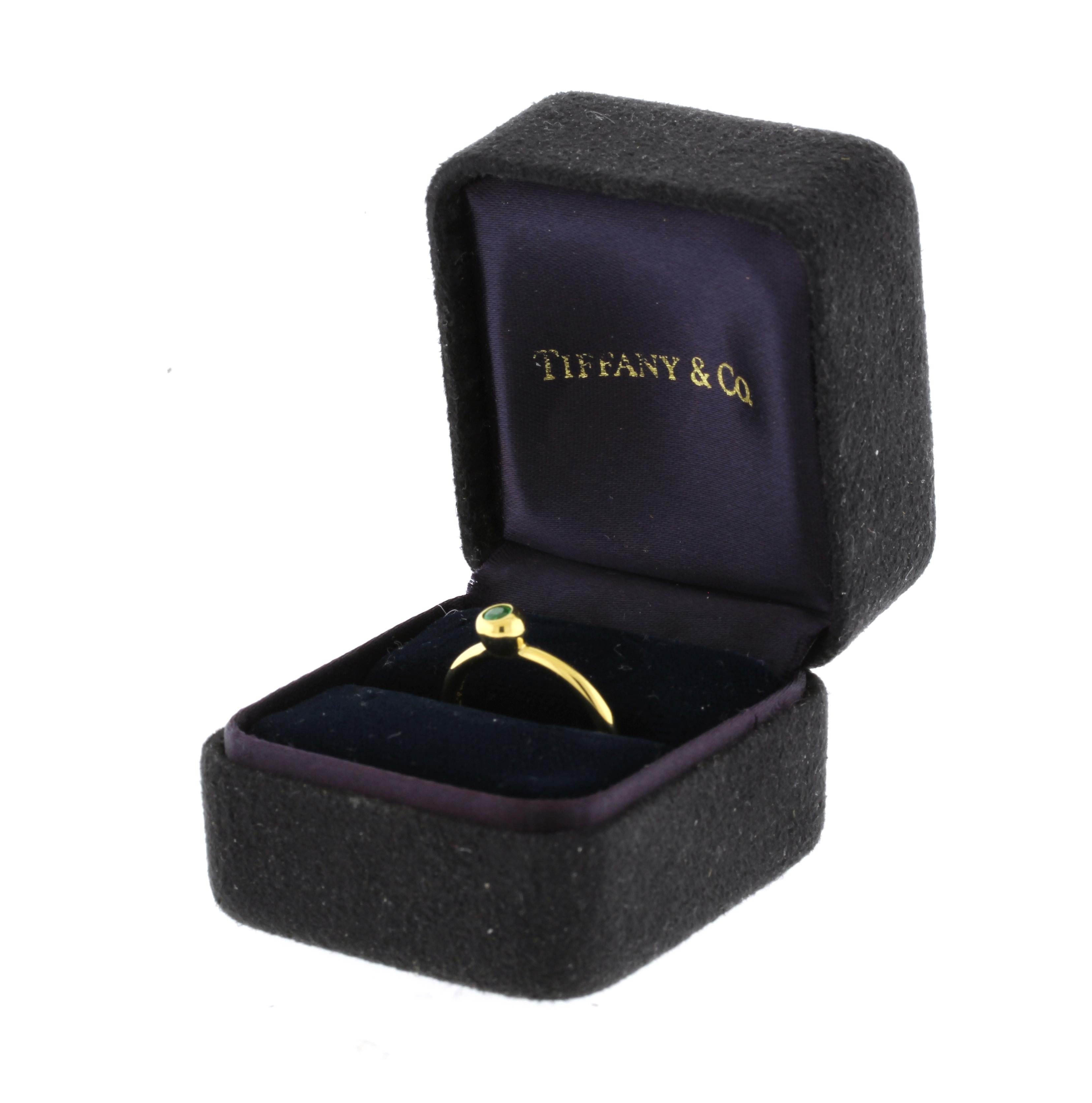 Paloma Picasso and Tiffany & Co. circa 1980s bezel set emerald ring in 18kt yellow gold. Ring is size 6 (adjustable) and weighs 3.1 grams. Emerald is approximately .09cts