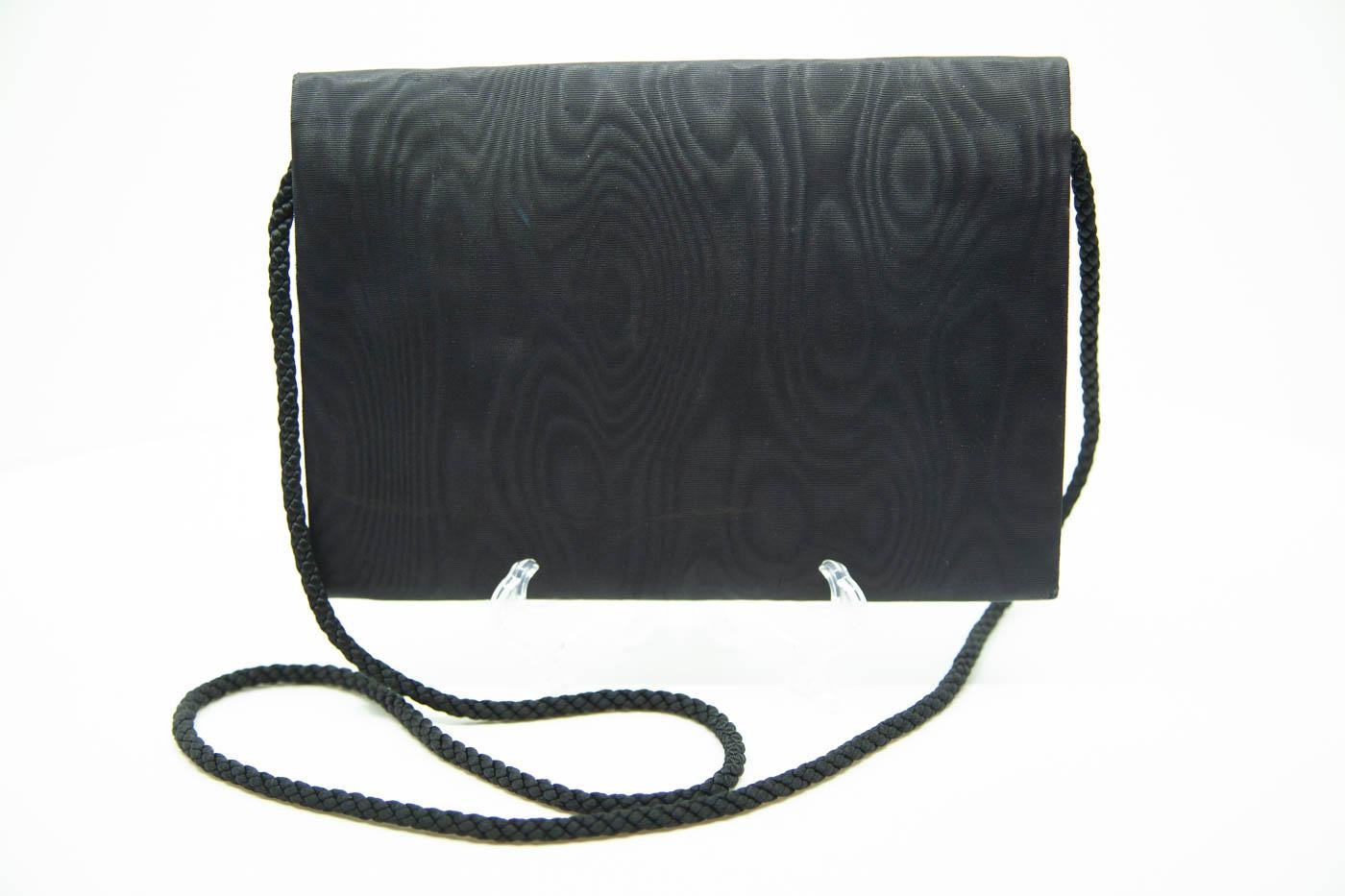 Paloma Picasso envelope purse for that very important letter or credit card. Narrow and small. Black envelope style with red circle at closure.

8