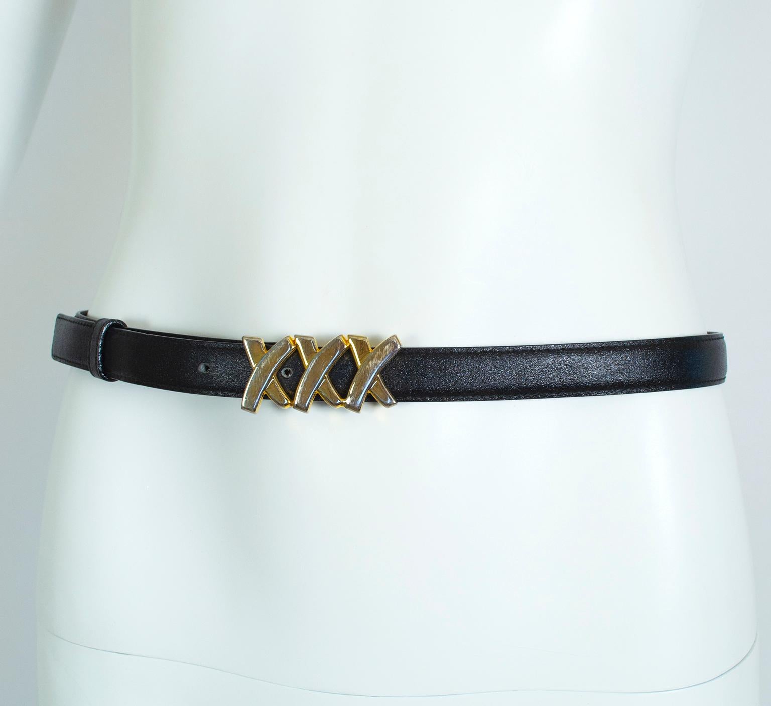 With its narrow profile, this glam Paloma Picasso belt will thread through all but the very skinniest belt loops and has just enough gold to complement your favorite Chanel 2.55 chain bag.

Black leather belt with gold hardware; tethered leather